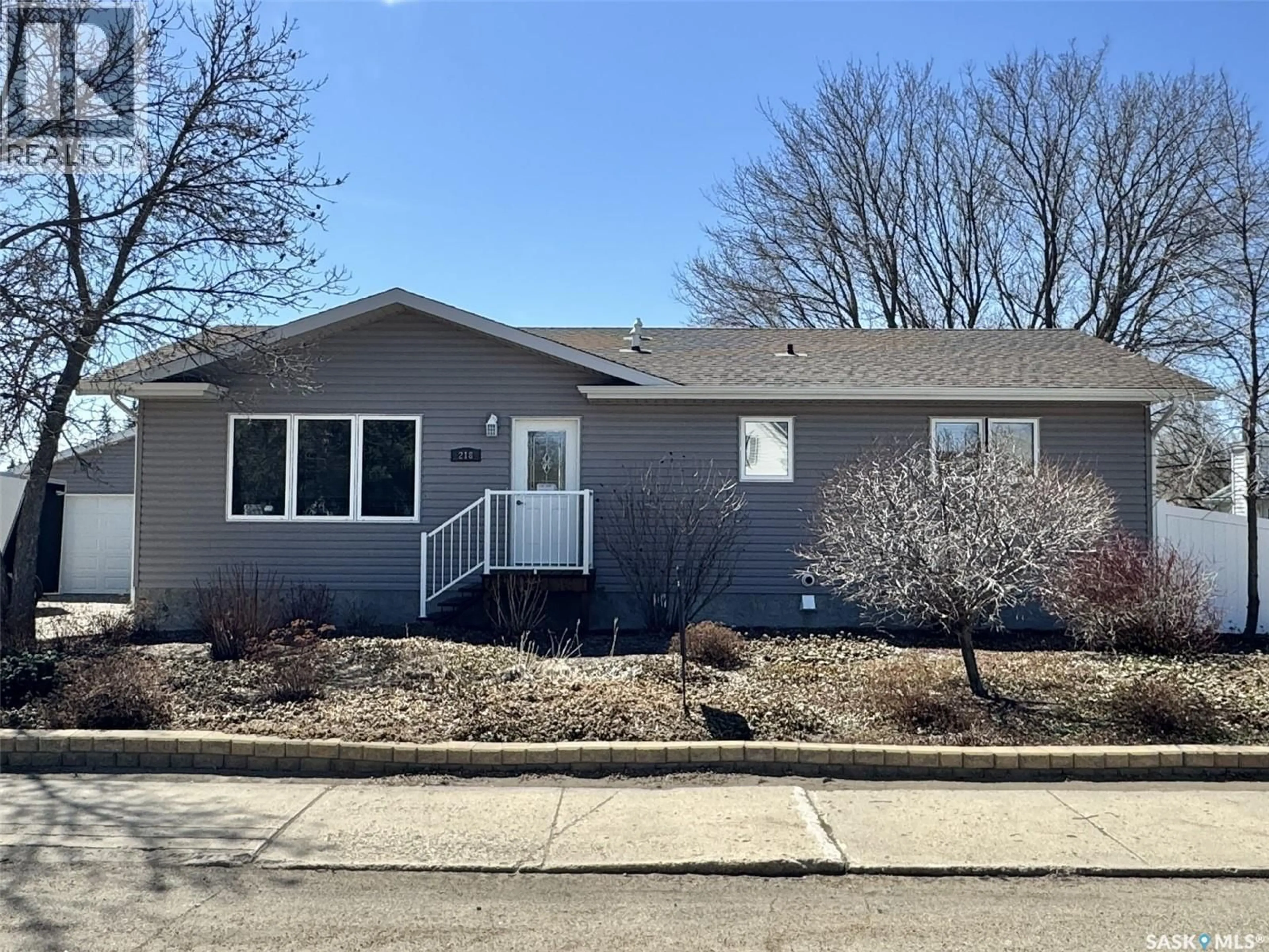 Home with vinyl exterior material, street for 218 5TH AVENUE, Biggar Saskatchewan S0K0M0