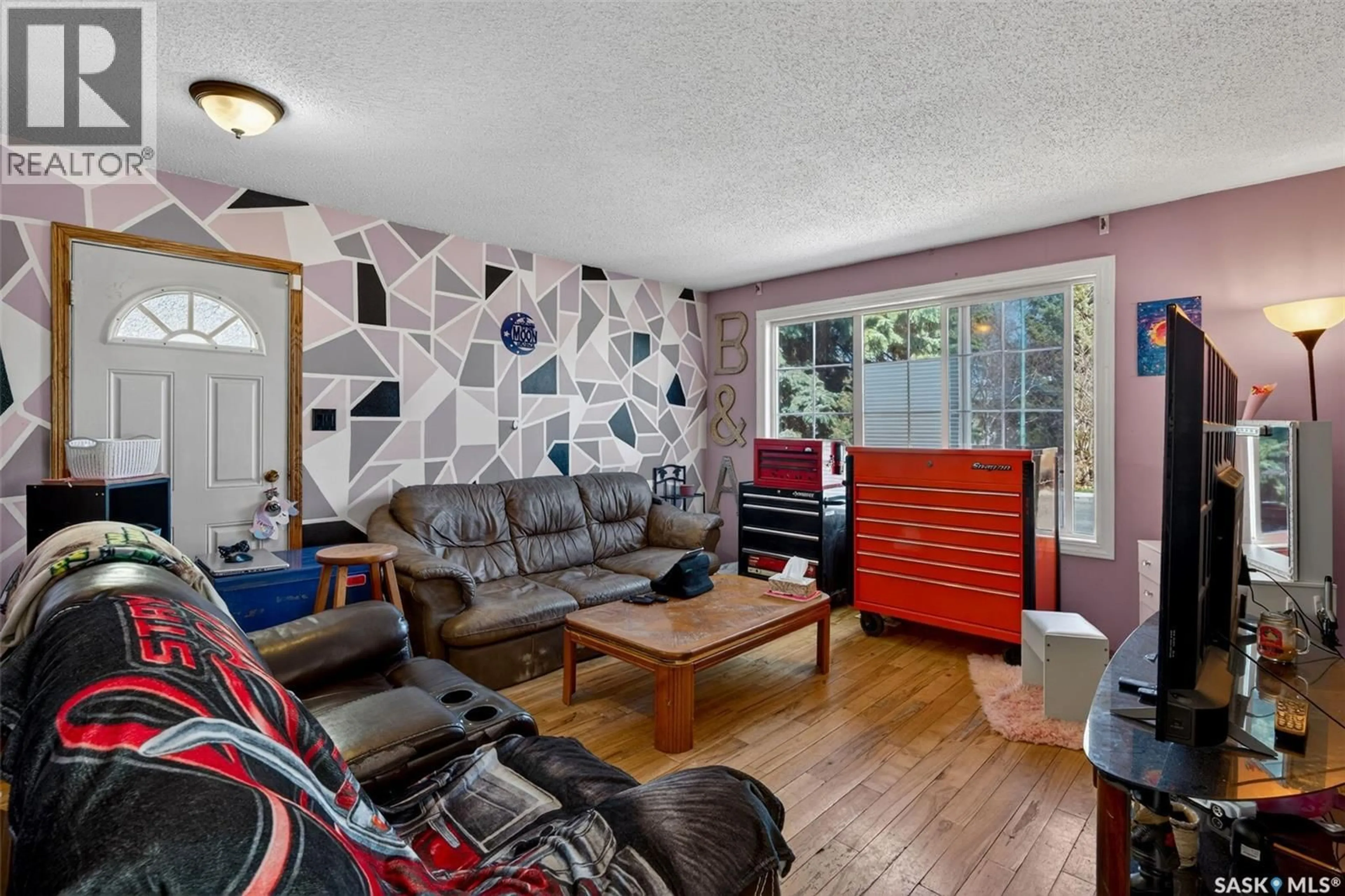 Living room with furniture, wood/laminate floor for 69 MCGEE CRESCENT, Saskatoon Saskatchewan S7L4M6