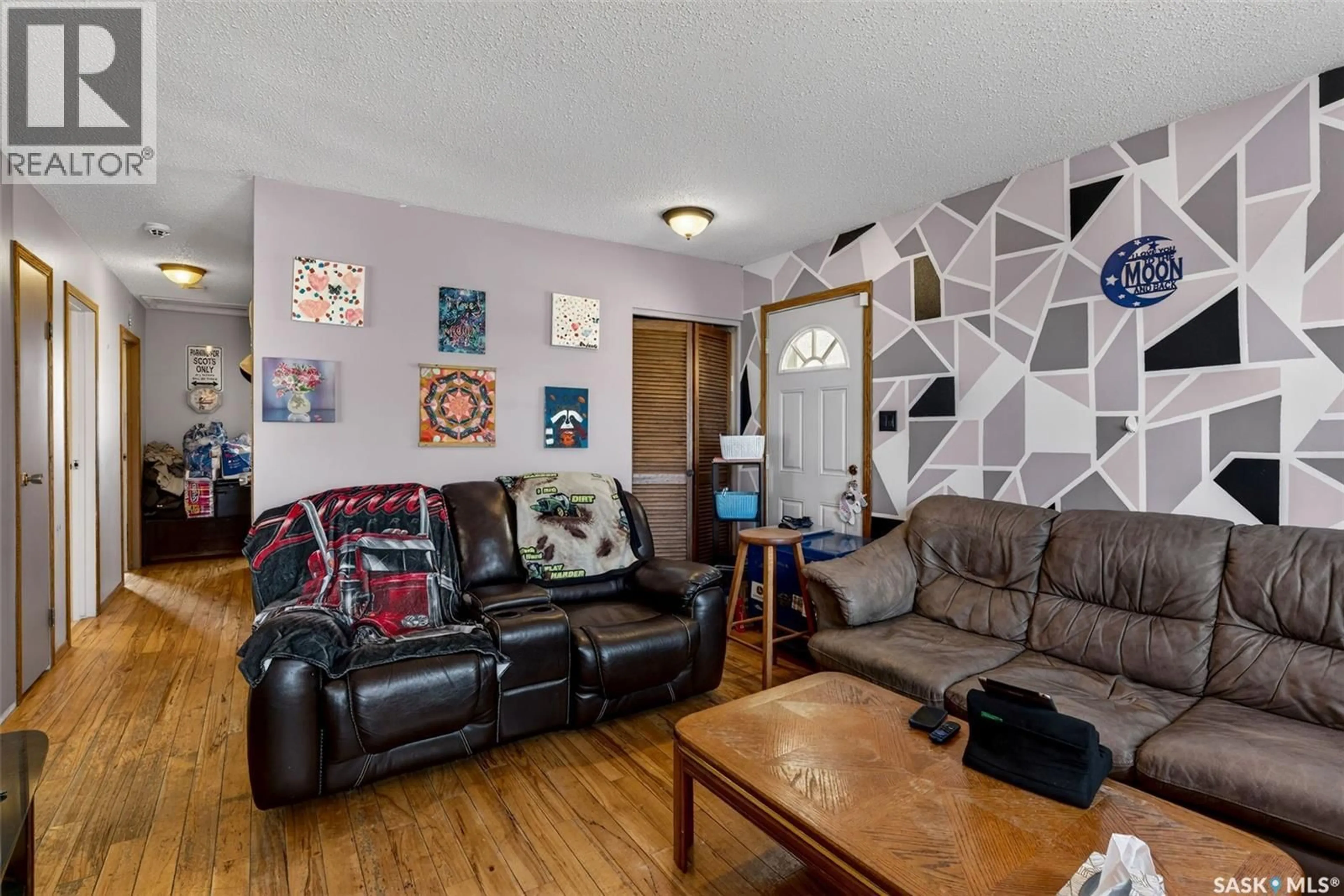 Living room with furniture, wood/laminate floor for 69 MCGEE CRESCENT, Saskatoon Saskatchewan S7L4M6