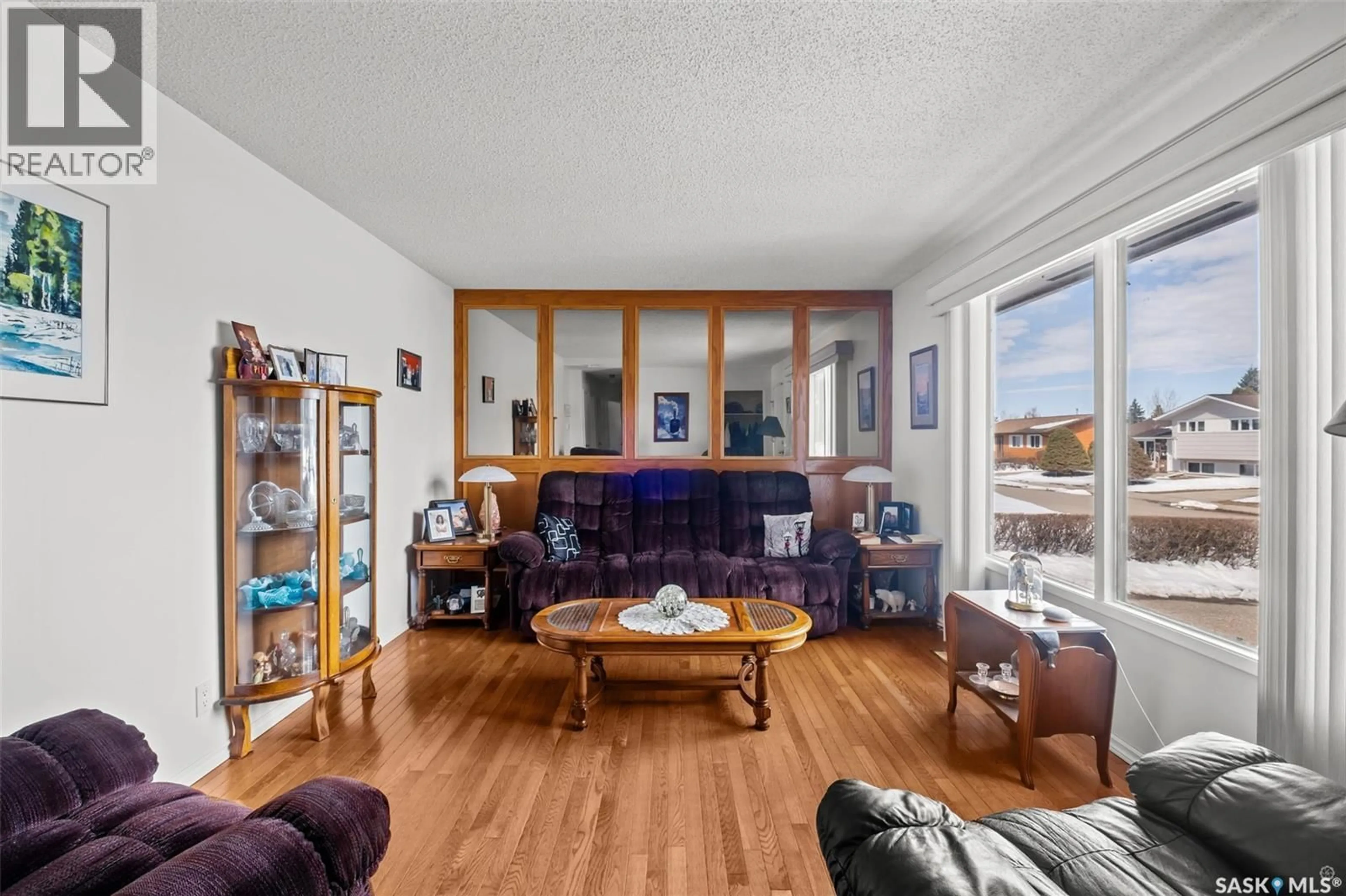 Living room with furniture, wood/laminate floor for 503 BENNETT DRIVE, Prince Albert Saskatchewan S6V6H5
