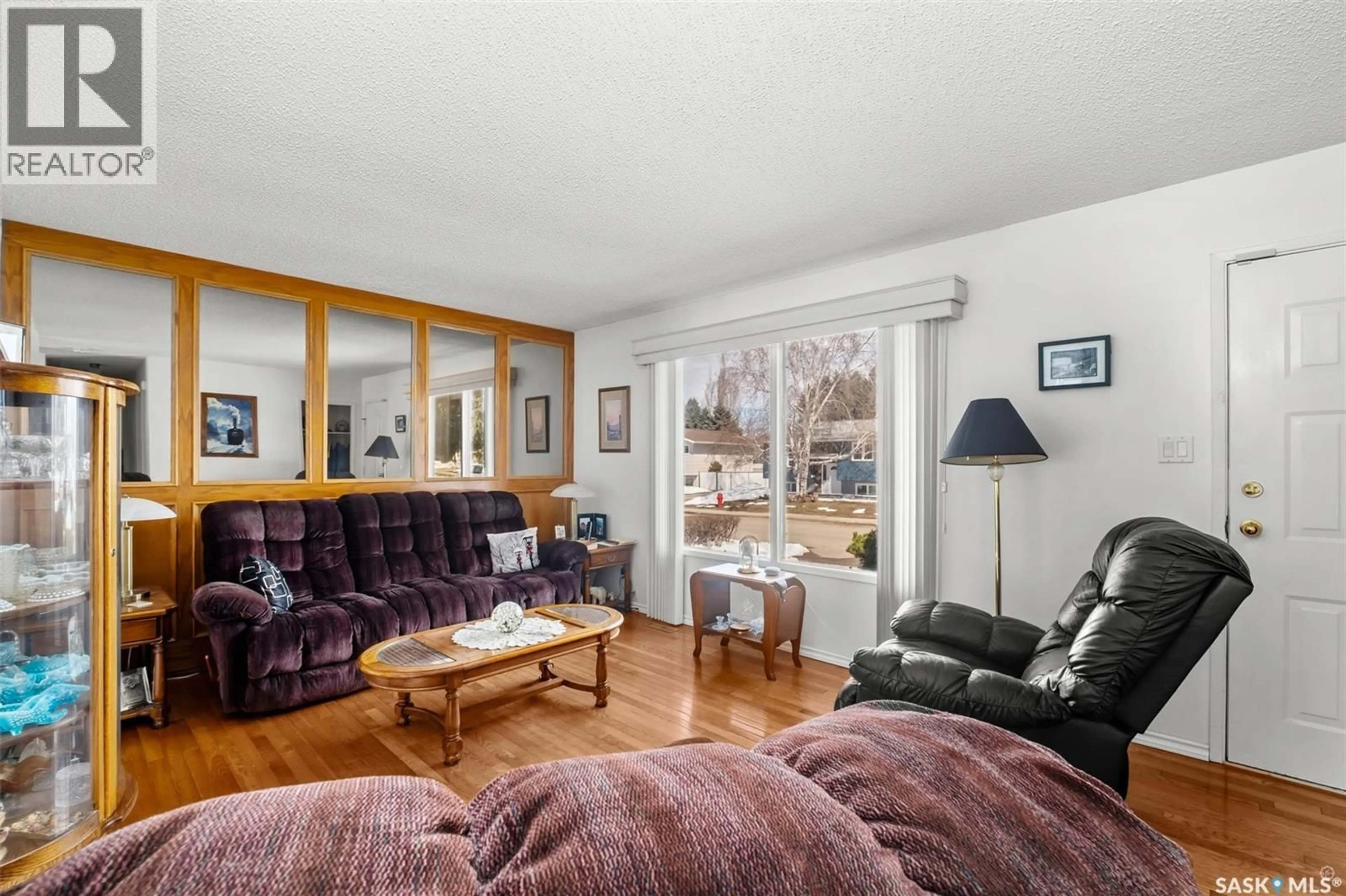 Living room with furniture, wood/laminate floor for 503 BENNETT DRIVE, Prince Albert Saskatchewan S6V6H5
