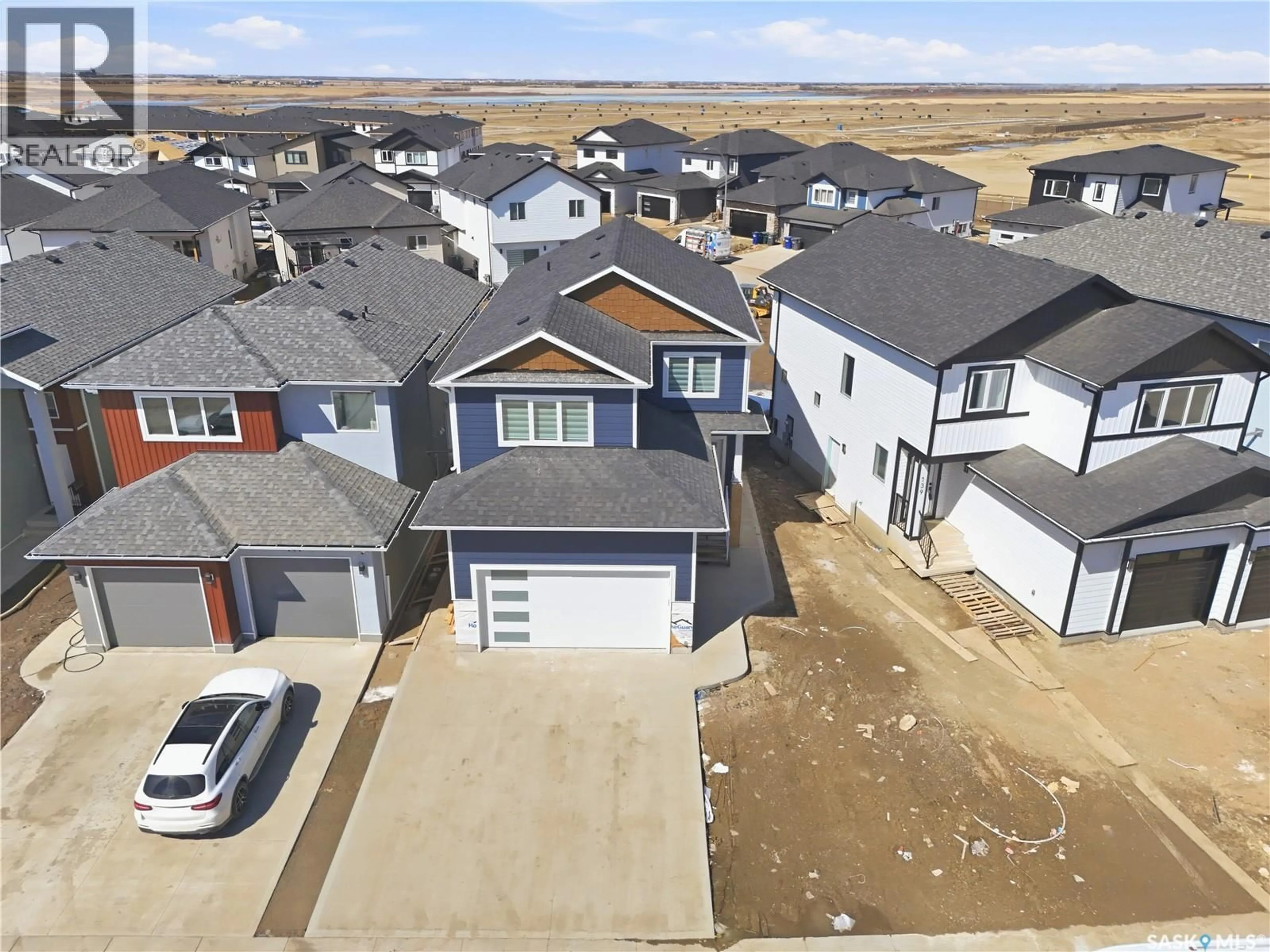 A pic from outside/outdoor area/front of a property/back of a property/a pic from drone, street for 143 SHARMA LANE, Saskatoon Saskatchewan S7W1L1