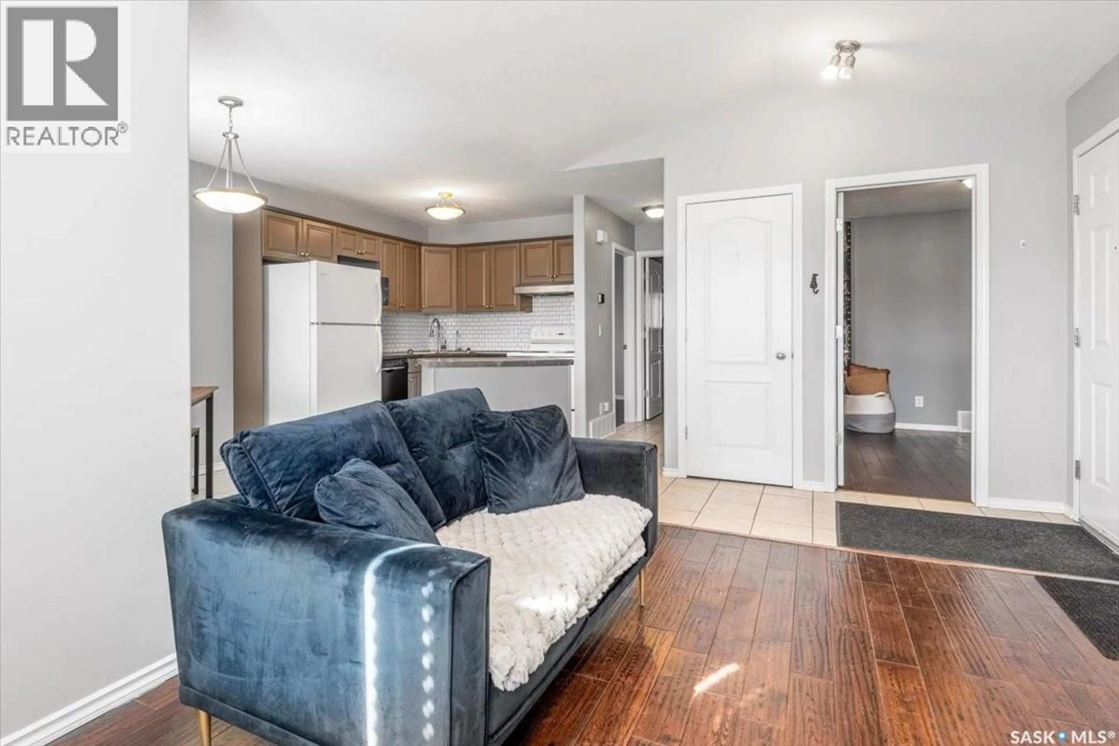 Living room with furniture, wood/laminate floor for E - 4044 BUCKINGHAM DRIVE, Regina Saskatchewan S4V3A9