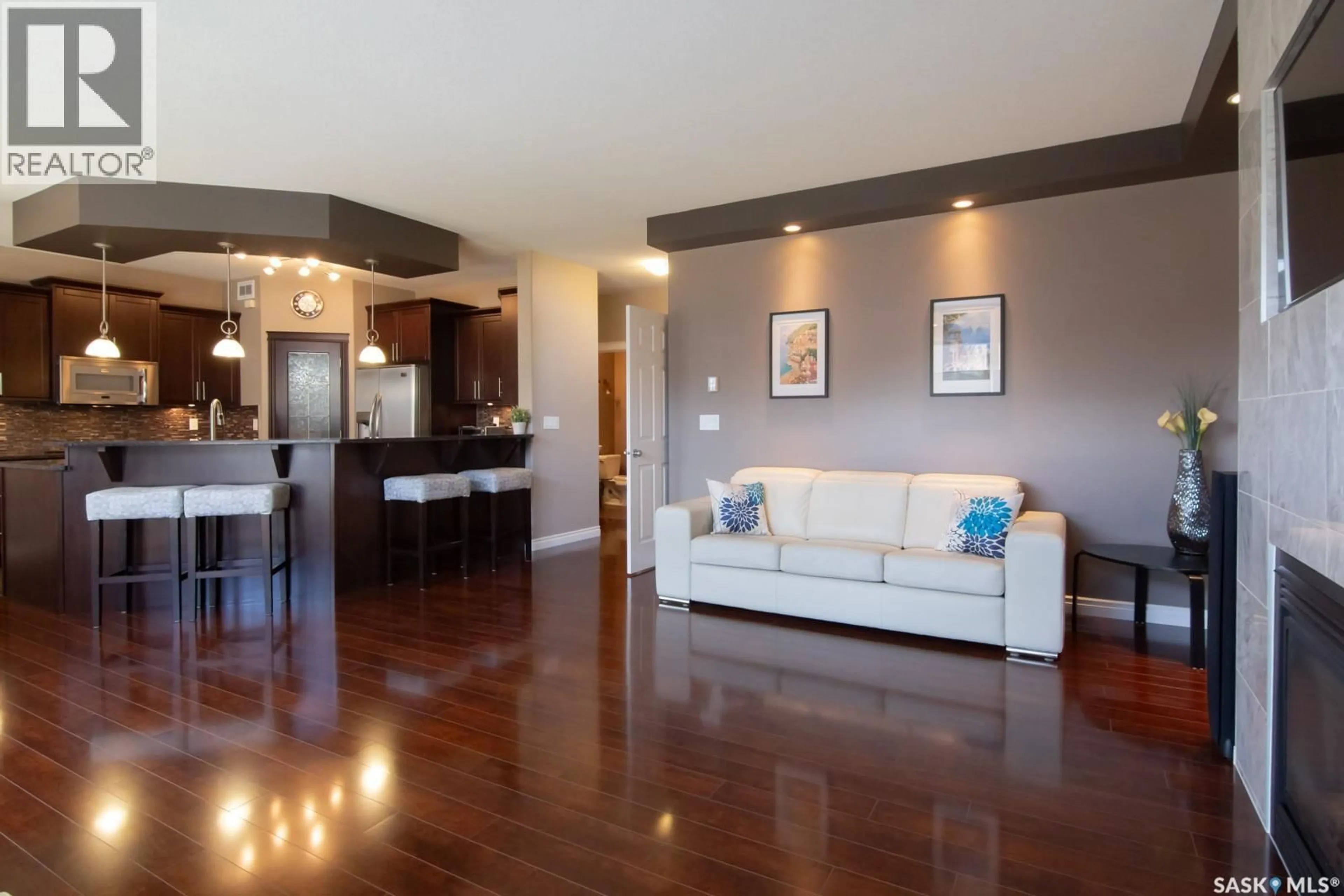 Living room with furniture, wood/laminate floor for 159 MASUDA TERRACE, Saskatoon Saskatchewan S7W0G9