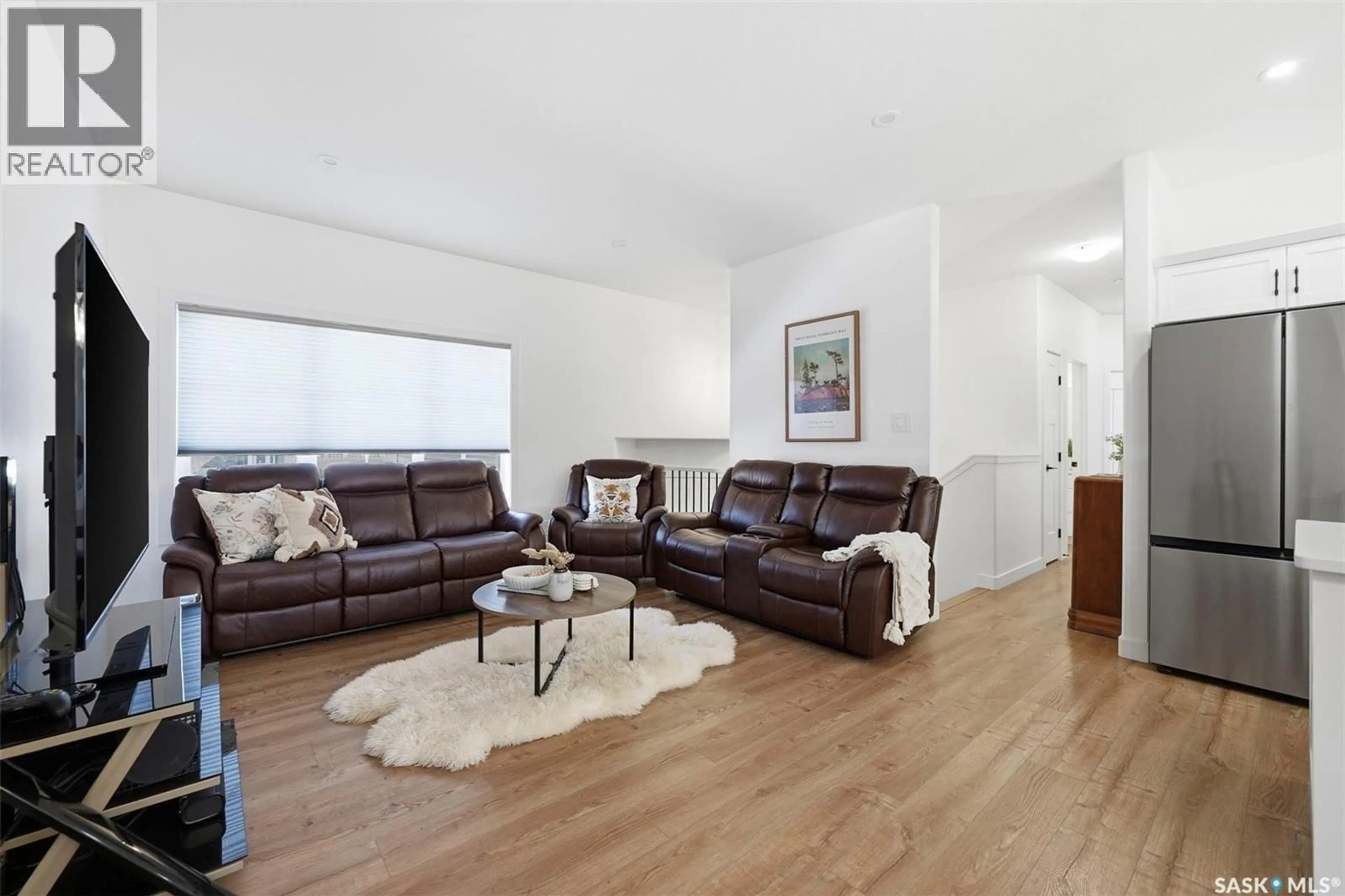 Living room with furniture, wood/laminate floor for 709 SARAZEN DRIVE, Warman Saskatchewan S0K4S4