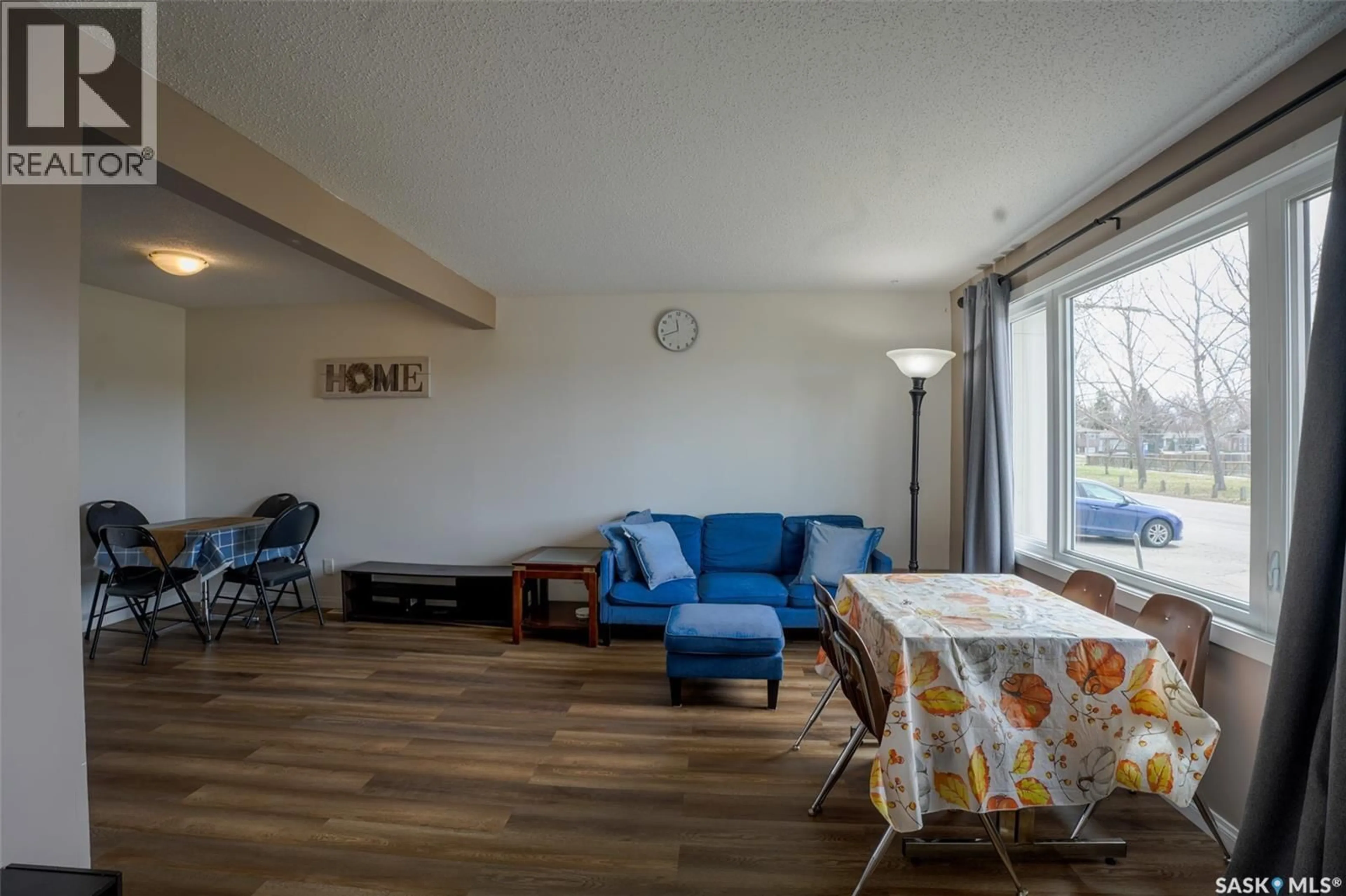 Living room with furniture, wood/laminate floor for 91 MACKENZIE WAY, Regina Saskatchewan S4N5M8
