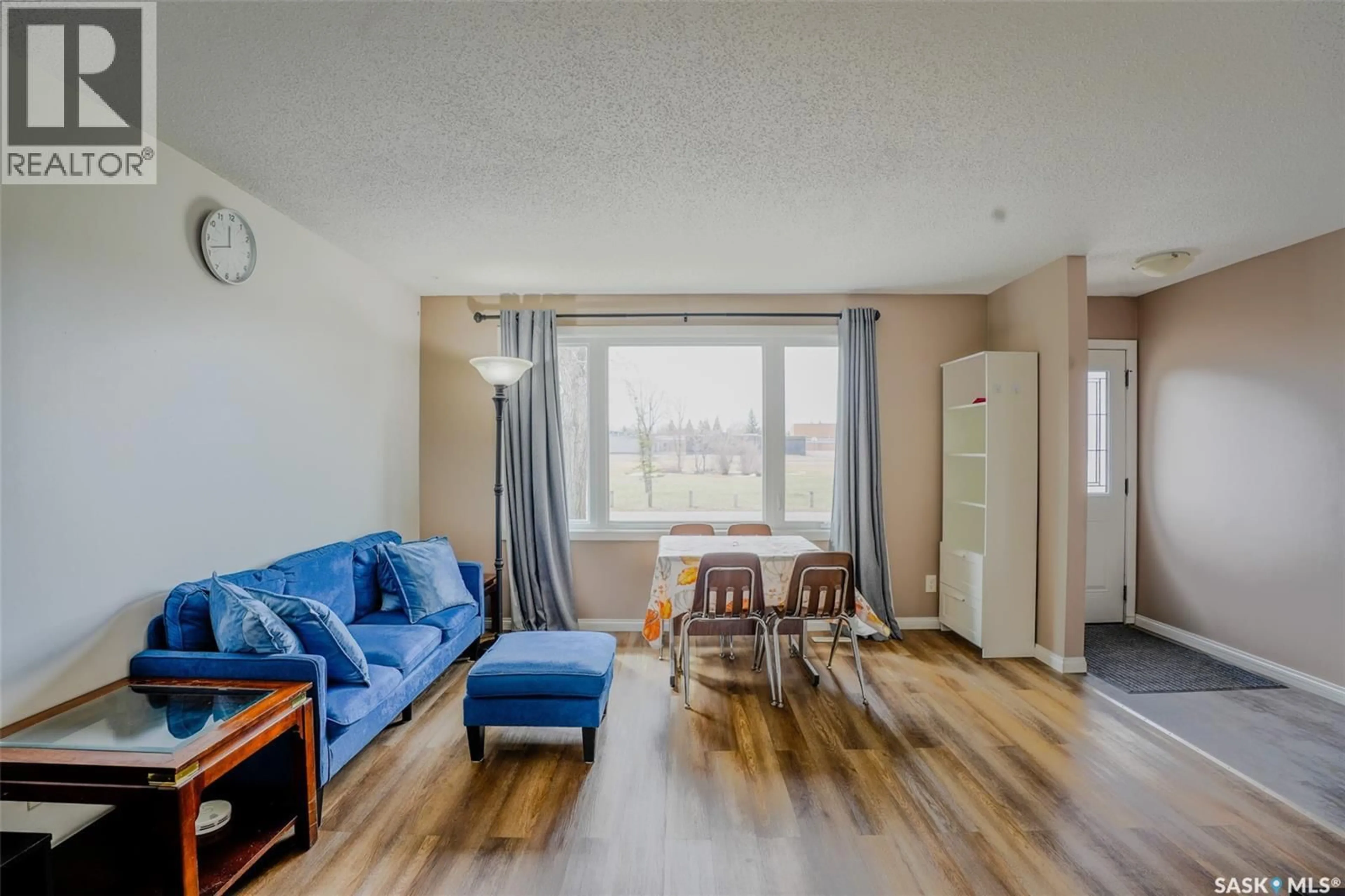 Living room with furniture, wood/laminate floor for 91 MACKENZIE WAY, Regina Saskatchewan S4N5M8