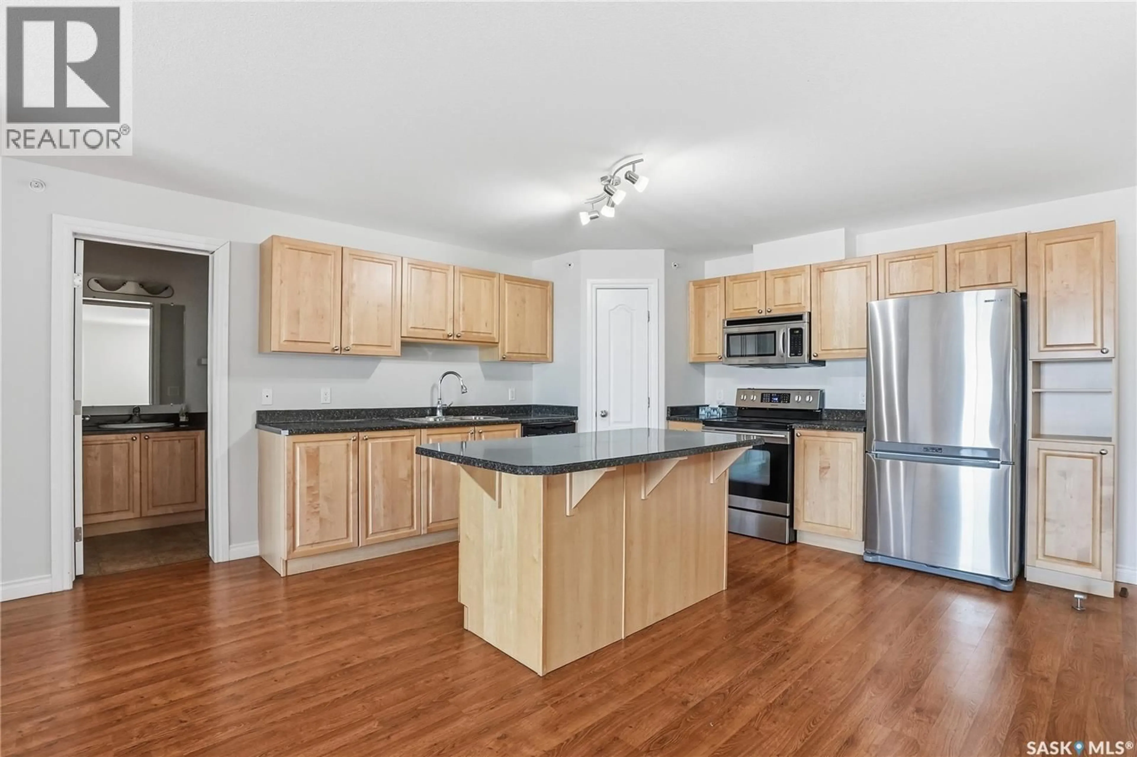 Open concept kitchen, wood/laminate floor for 100 - 405 1ST AVENUE, Warman Saskatchewan S0K0A1
