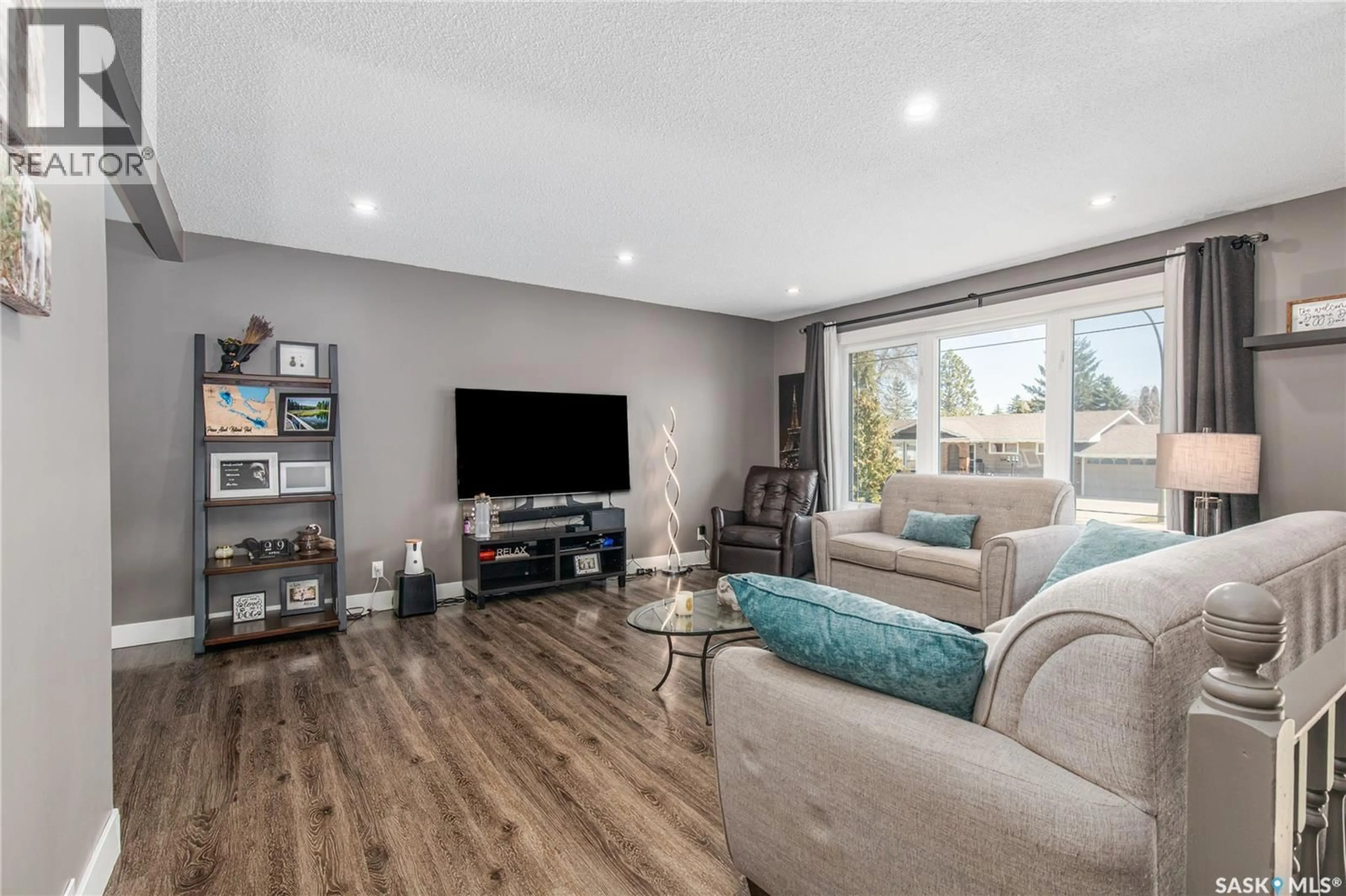 Living room with furniture, wood/laminate floor for 1267 MAYBERY CRESCENT, Moose Jaw Saskatchewan S6H6X7