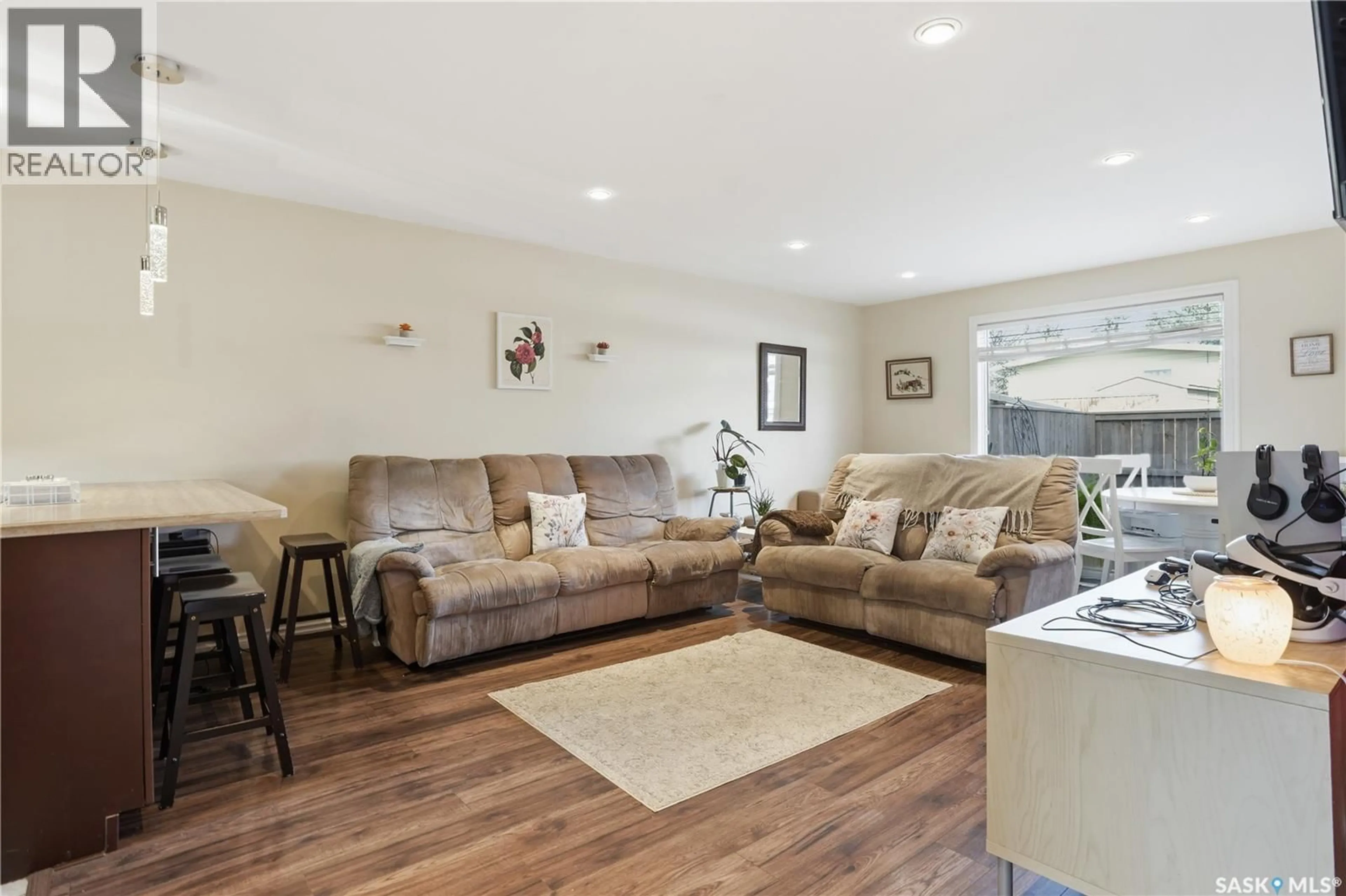 Living room with furniture, wood/laminate floor for 7 KILLARNEY WAY, Regina Saskatchewan S4S6V9