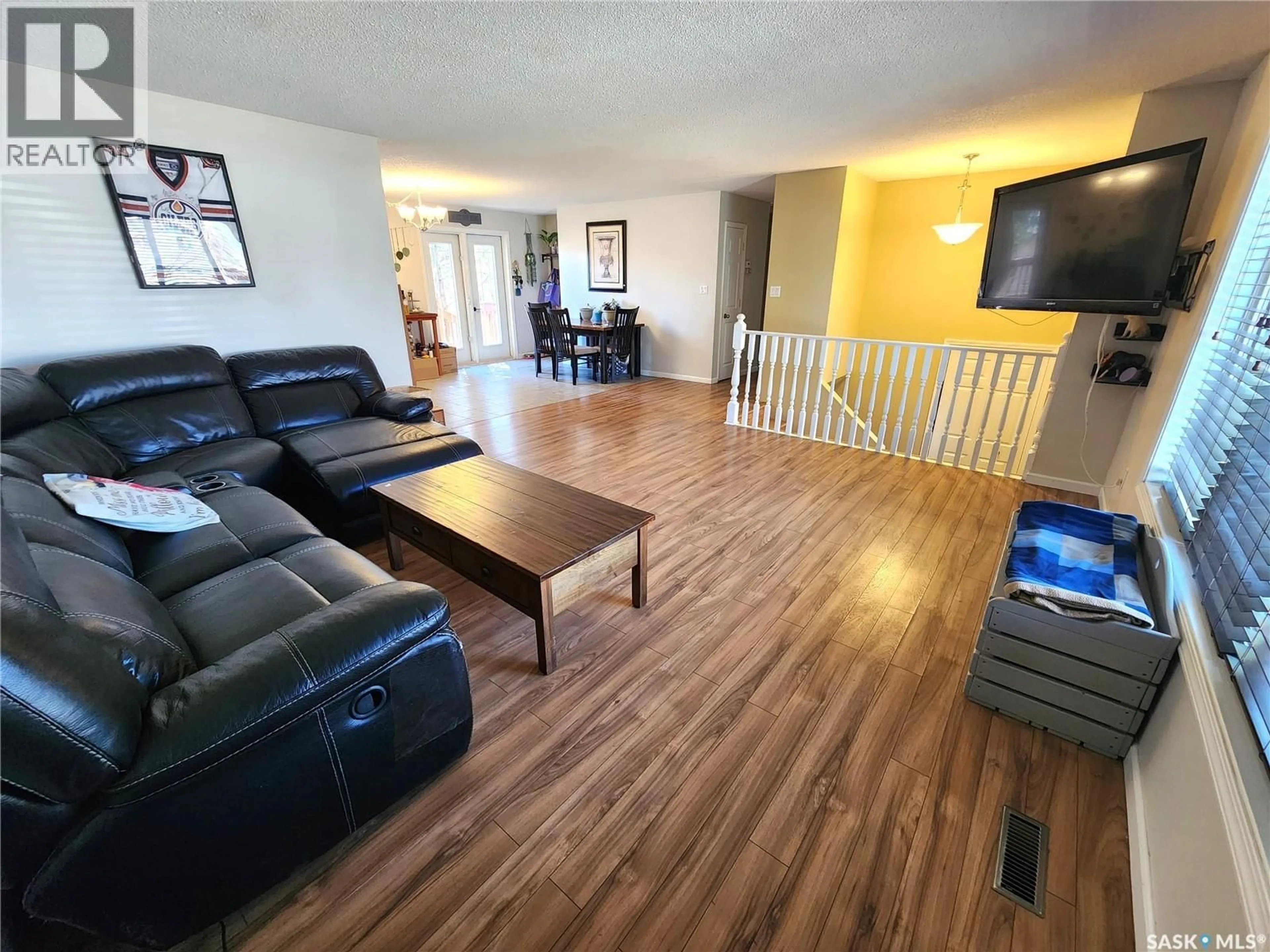 Living room with furniture, wood/laminate floor for 1330 8TH STREET, Estevan Saskatchewan S4A1H6