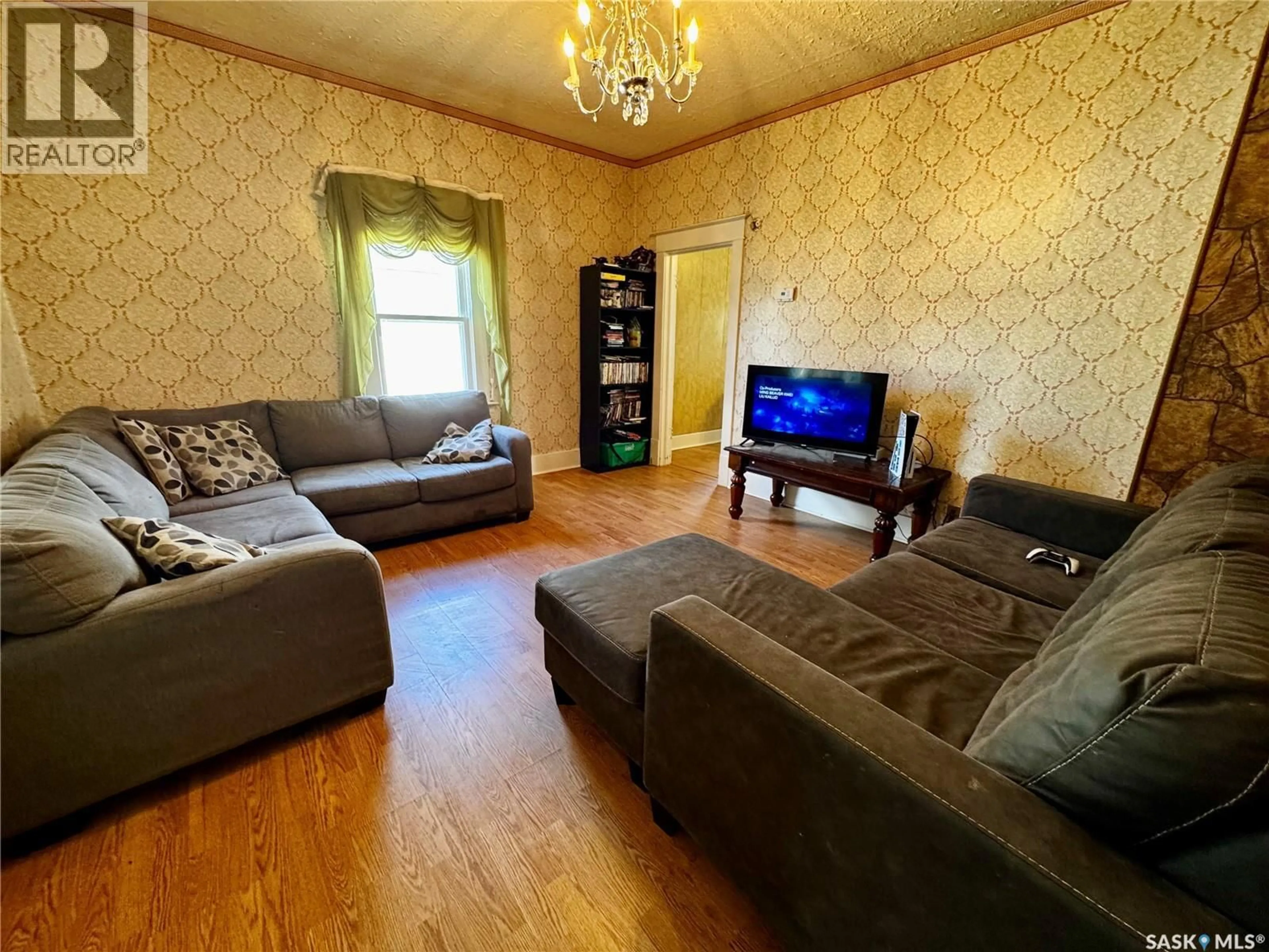 Living room with furniture, wood/laminate floor for 305 3RD AVENUE, Swift Current Saskatchewan S9H2G8