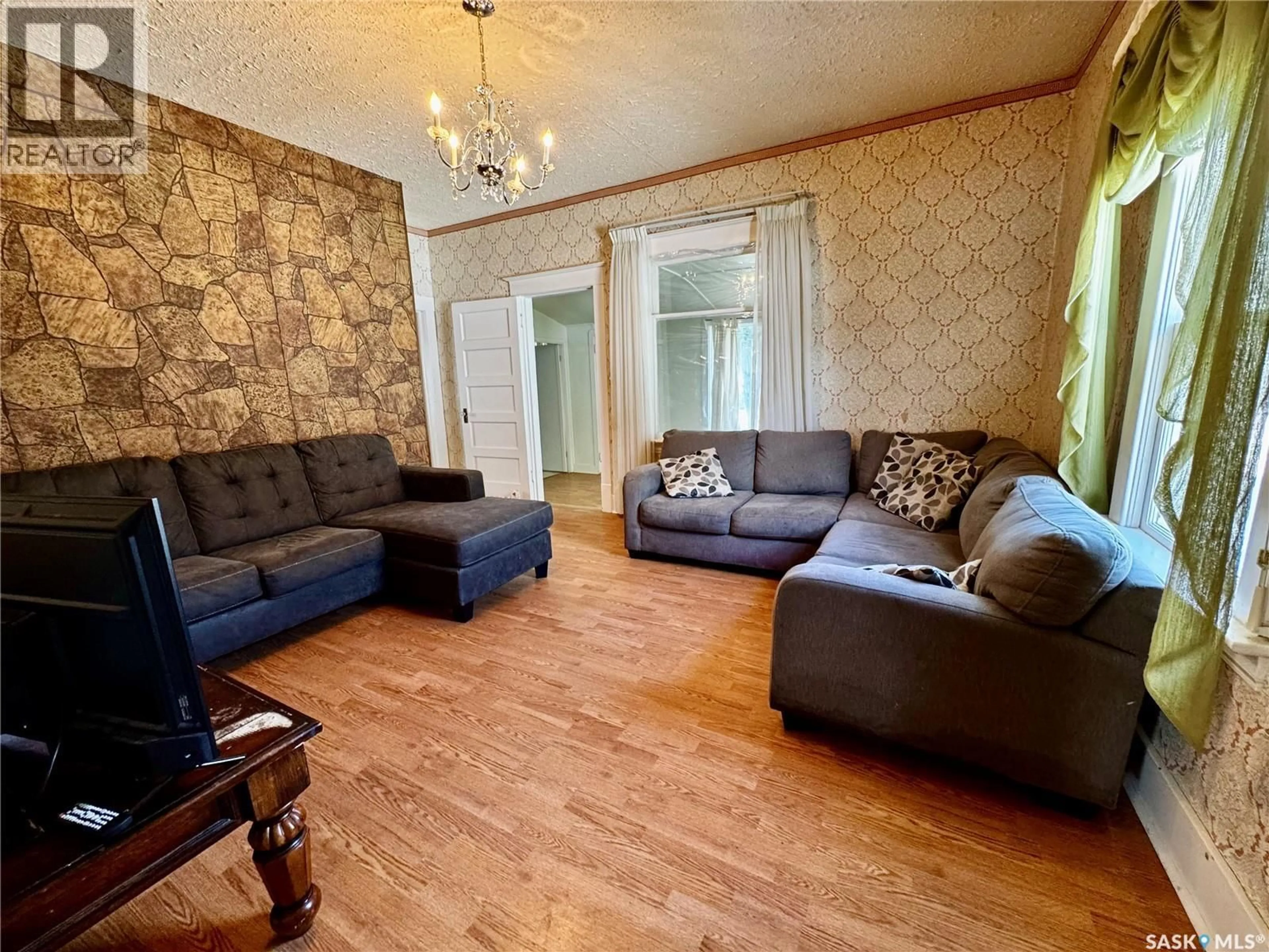 Living room with furniture, wood/laminate floor for 305 3RD AVENUE, Swift Current Saskatchewan S9H2G8