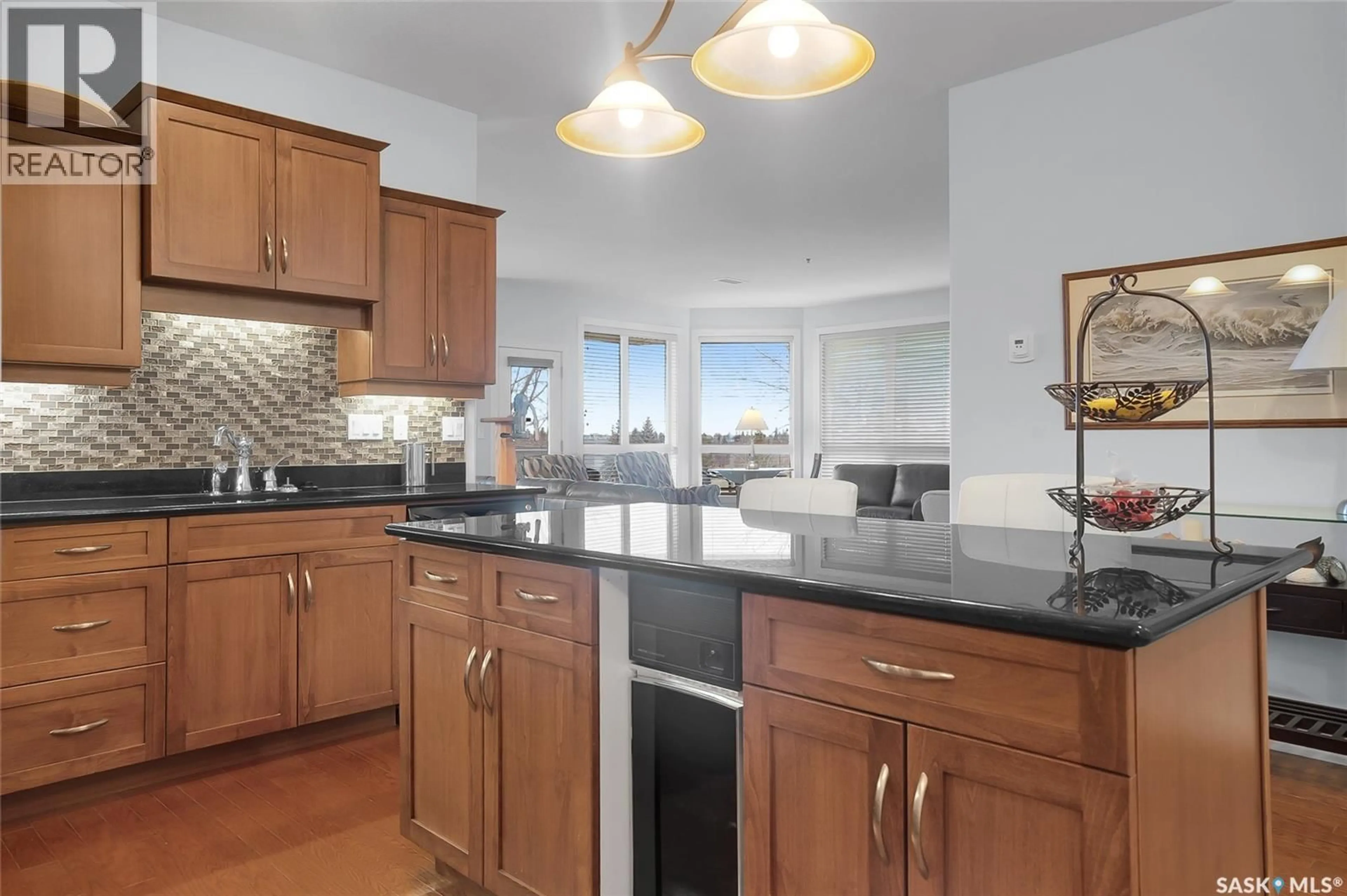 Open concept kitchen, ceramic/tile floor for 204 - 401 CARTWRIGHT STREET, Saskatoon Saskatchewan S7T0B3