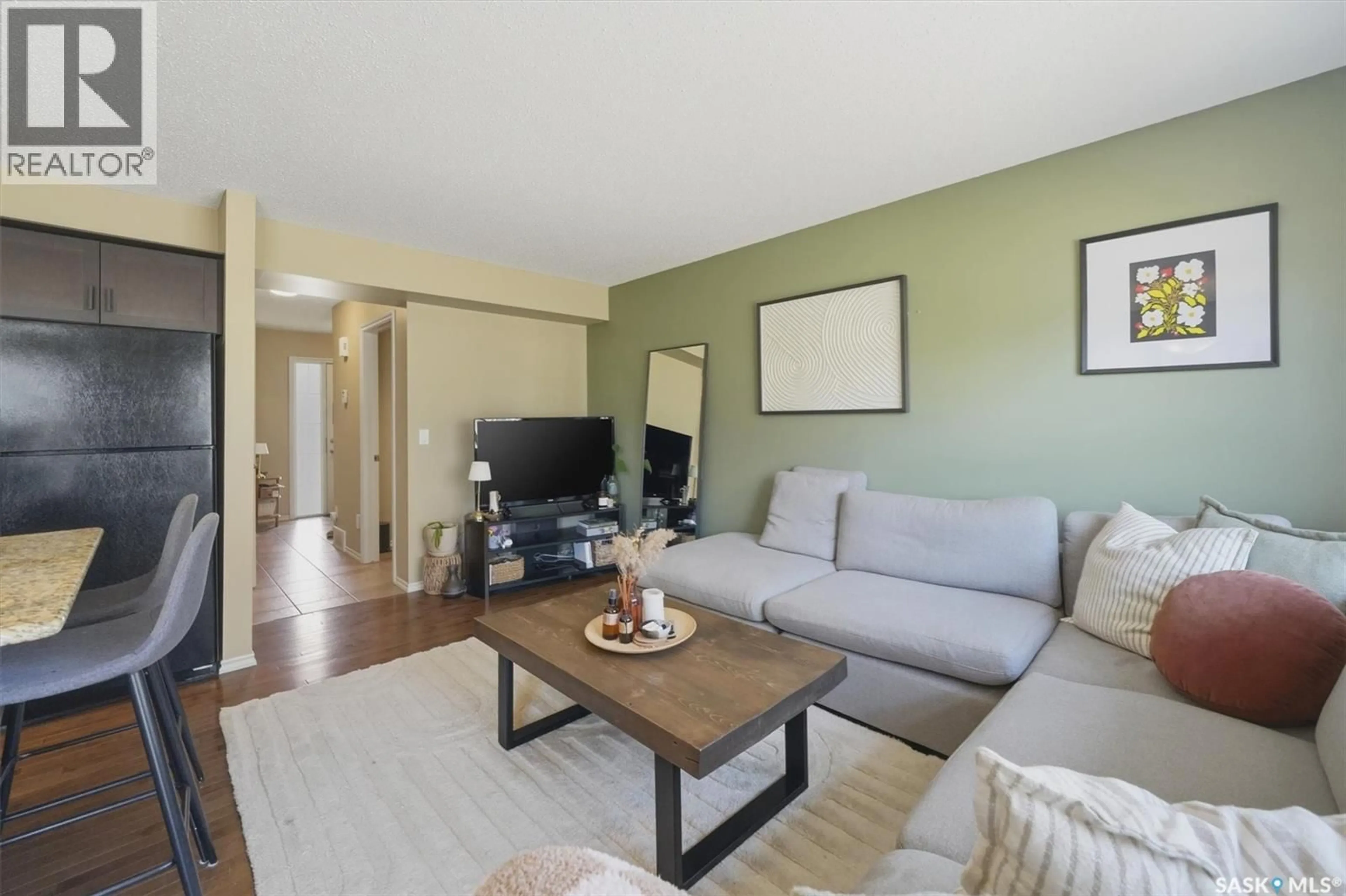 Living room with furniture, wood/laminate floor for 105 LYND CRESCENT, Saskatoon Saskatchewan S7T0C3