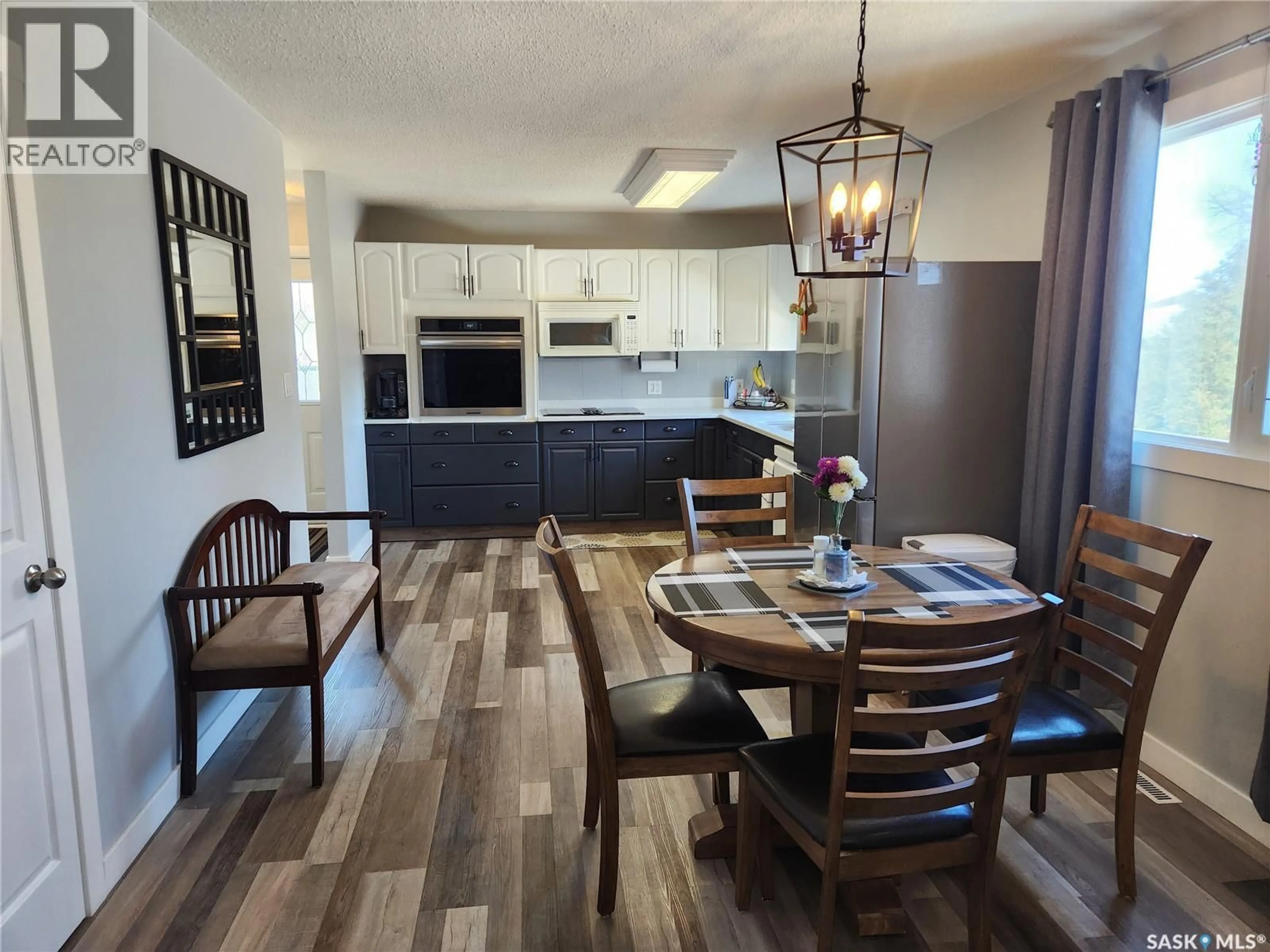 Open concept kitchen, wood/laminate floor for 1305 95TH STREET, Tisdale Saskatchewan S0E1T0