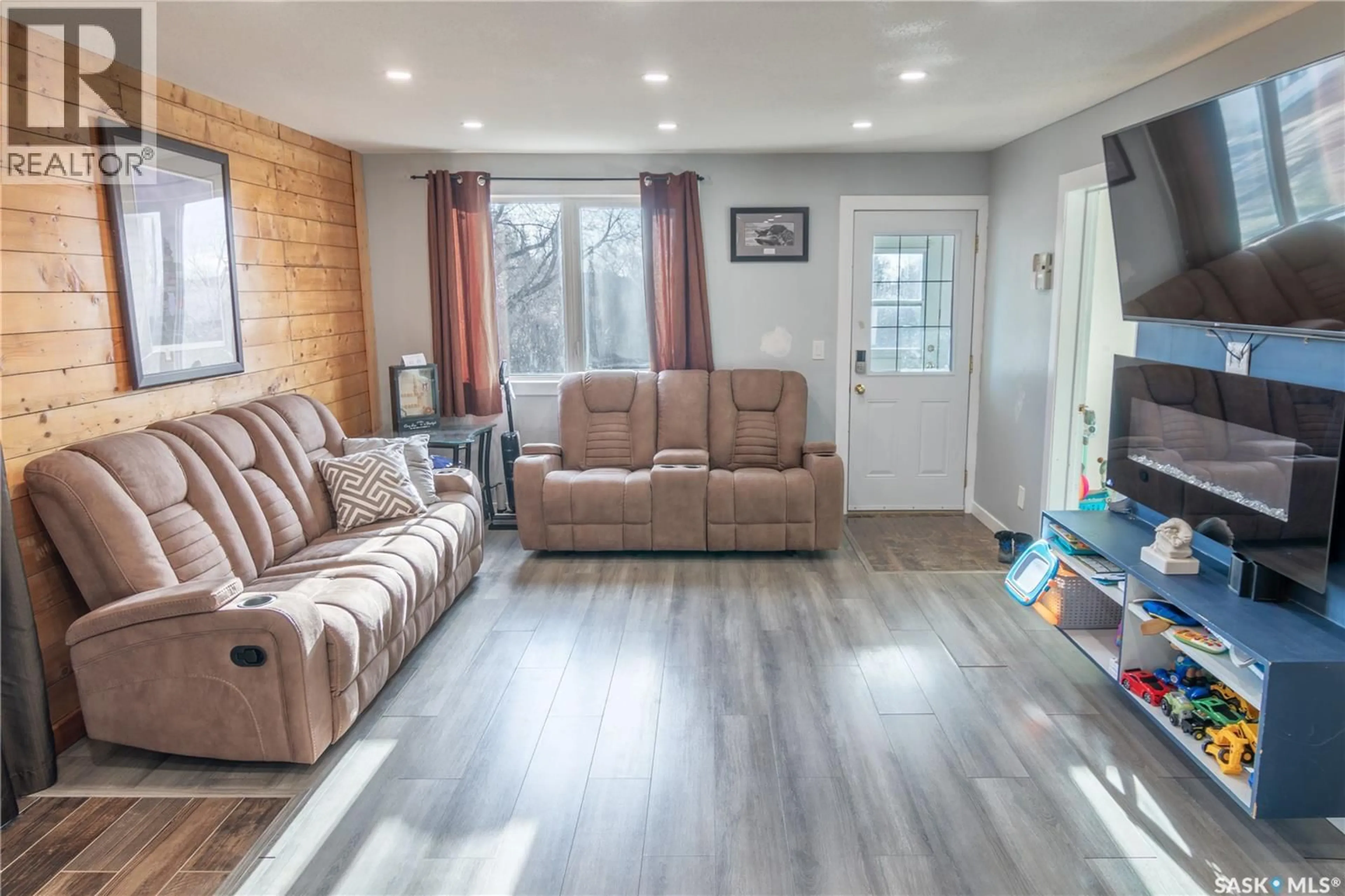 Living room with furniture, wood/laminate floor for 104 BREWER STREET, Edenwold Saskatchewan S0G1K0