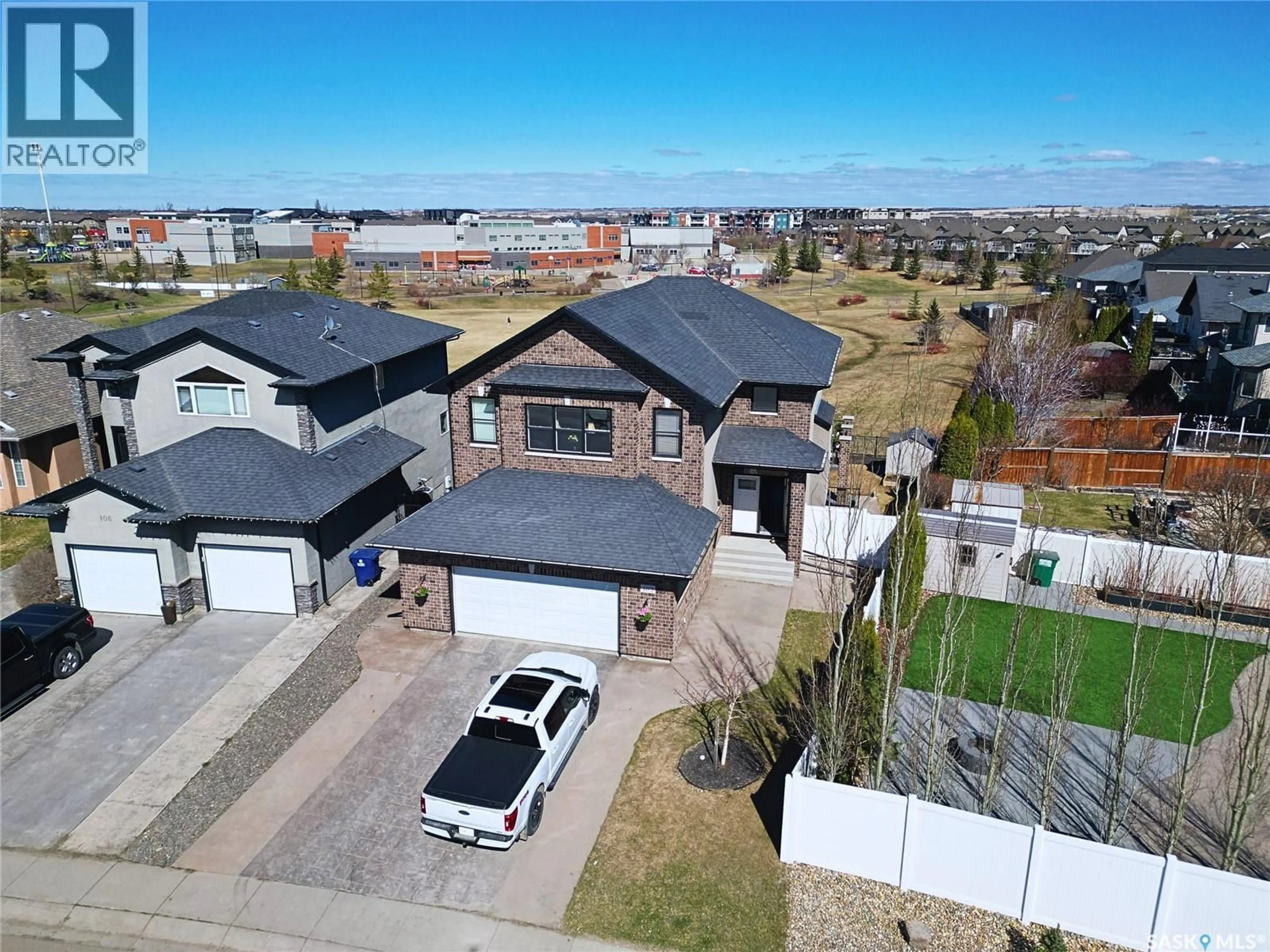 A pic from outside/outdoor area/front of a property/back of a property/a pic from drone, street for 102 THODE AVENUE, Saskatoon Saskatchewan S7W1A1