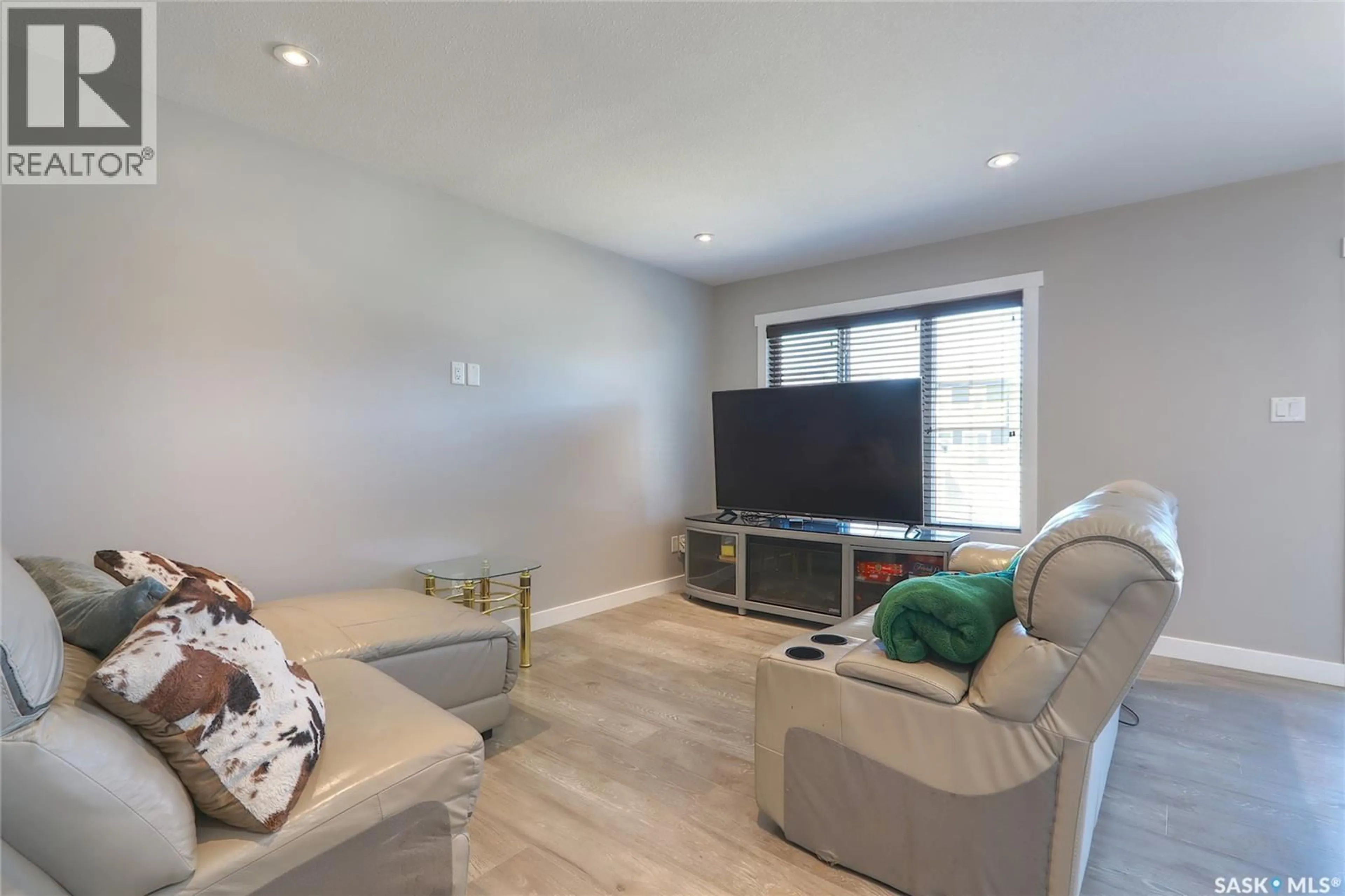Living room with furniture, wood/laminate floor for 1732 MUSTARD STREET, Regina Saskatchewan S4Y0G1