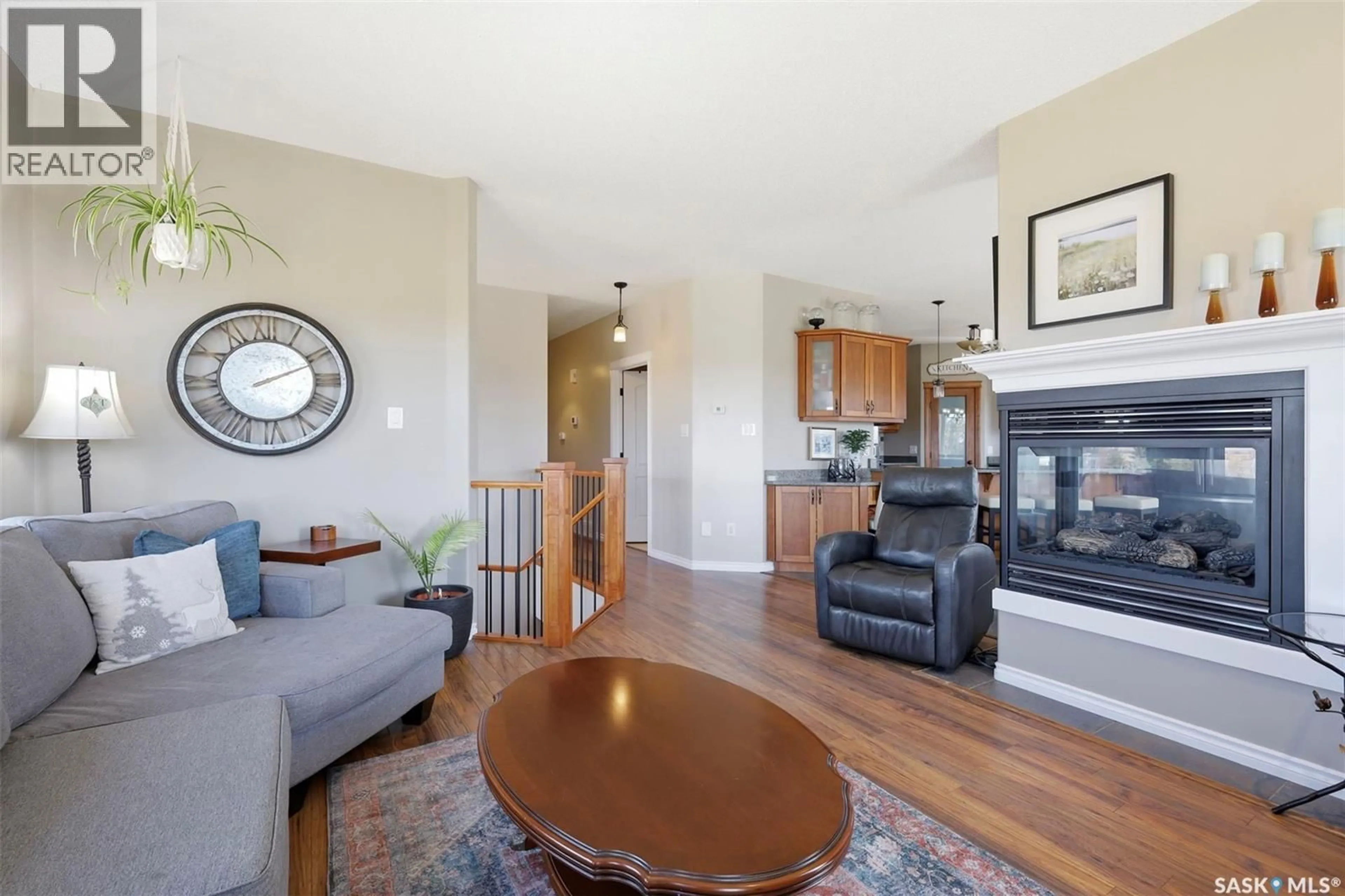 Living room with furniture, wood/laminate floor for T&T ACRES, Corman Park Rm No. 344 Saskatchewan S7K3J5