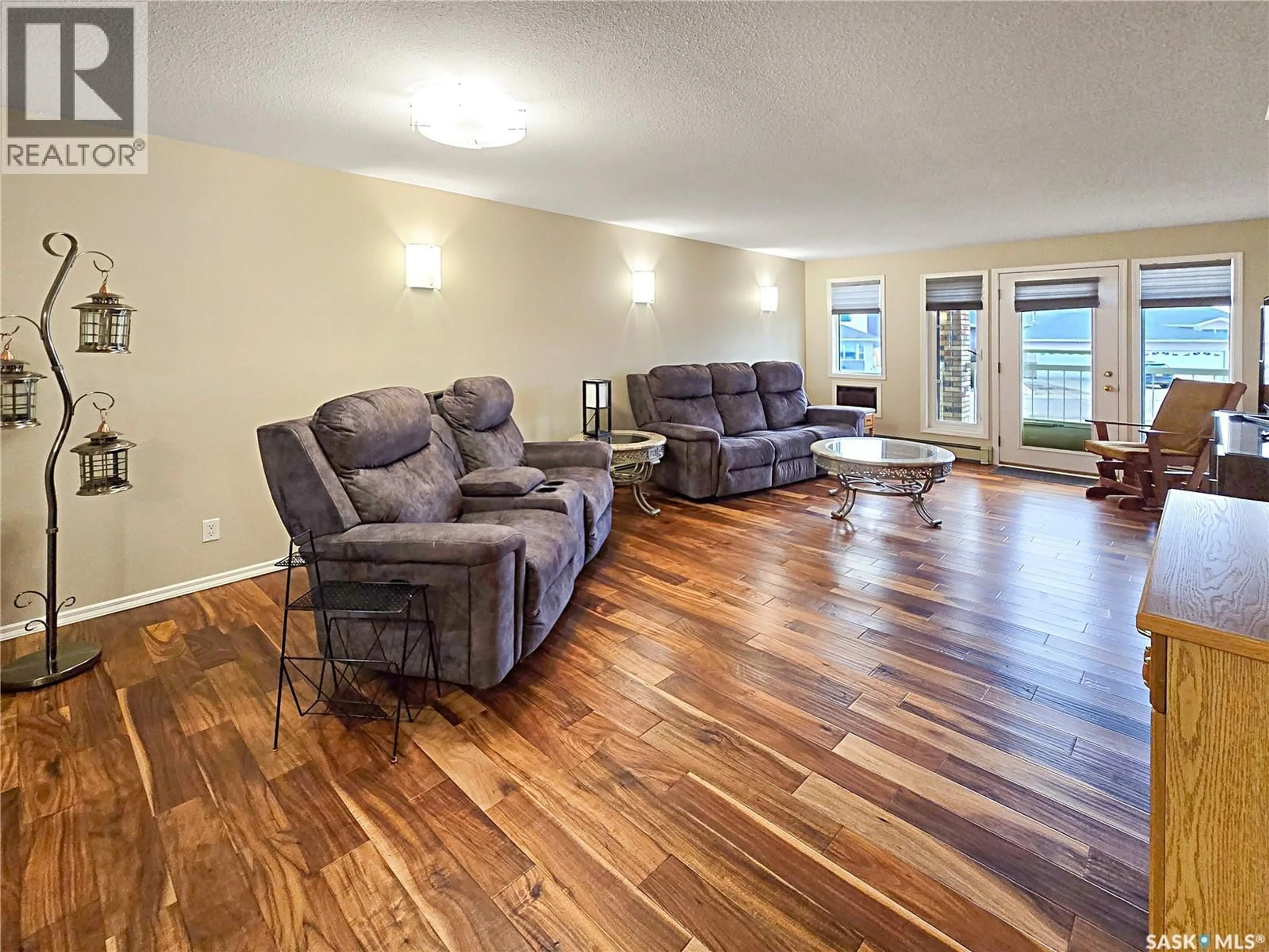 Living room with furniture, wood/laminate floor for 103 27 ERICHSEN PLACE, Yorkton Saskatchewan S3N3Z6