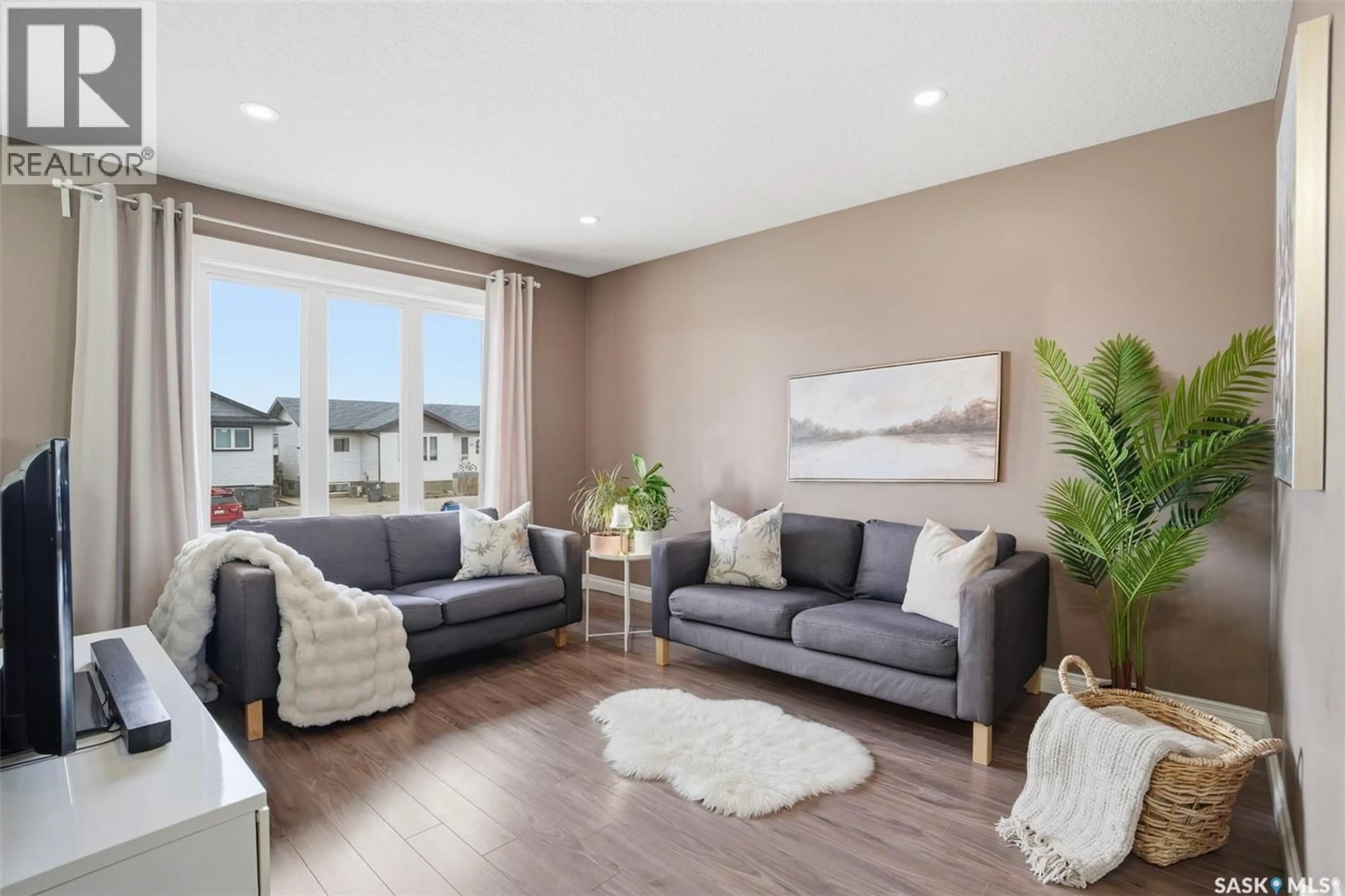 Living room with furniture, wood/laminate floor for 304 MARTENS AVENUE, Warman Saskatchewan S0K4S3