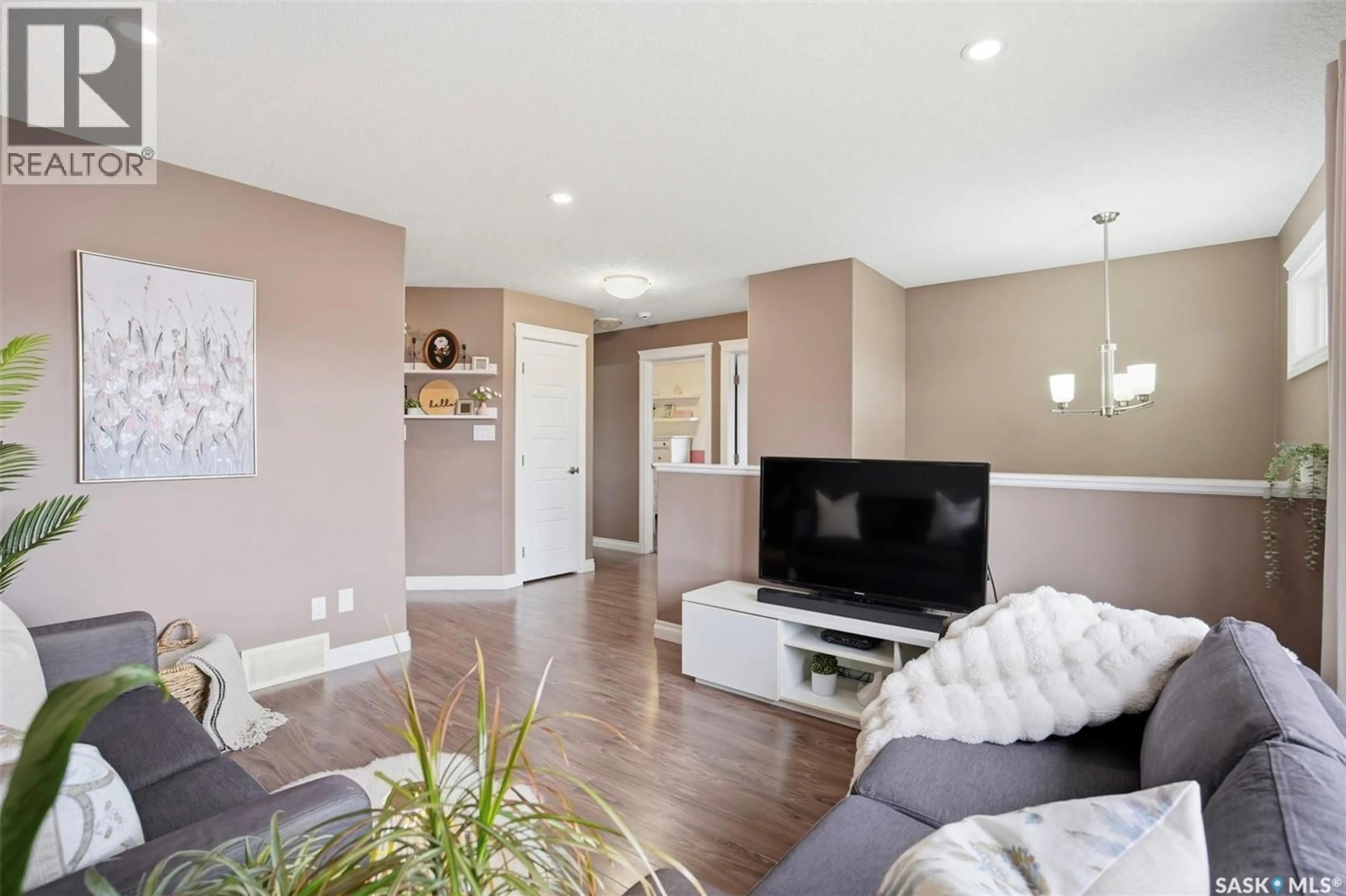 Living room with furniture, wood/laminate floor for 304 MARTENS AVENUE, Warman Saskatchewan S0K4S3