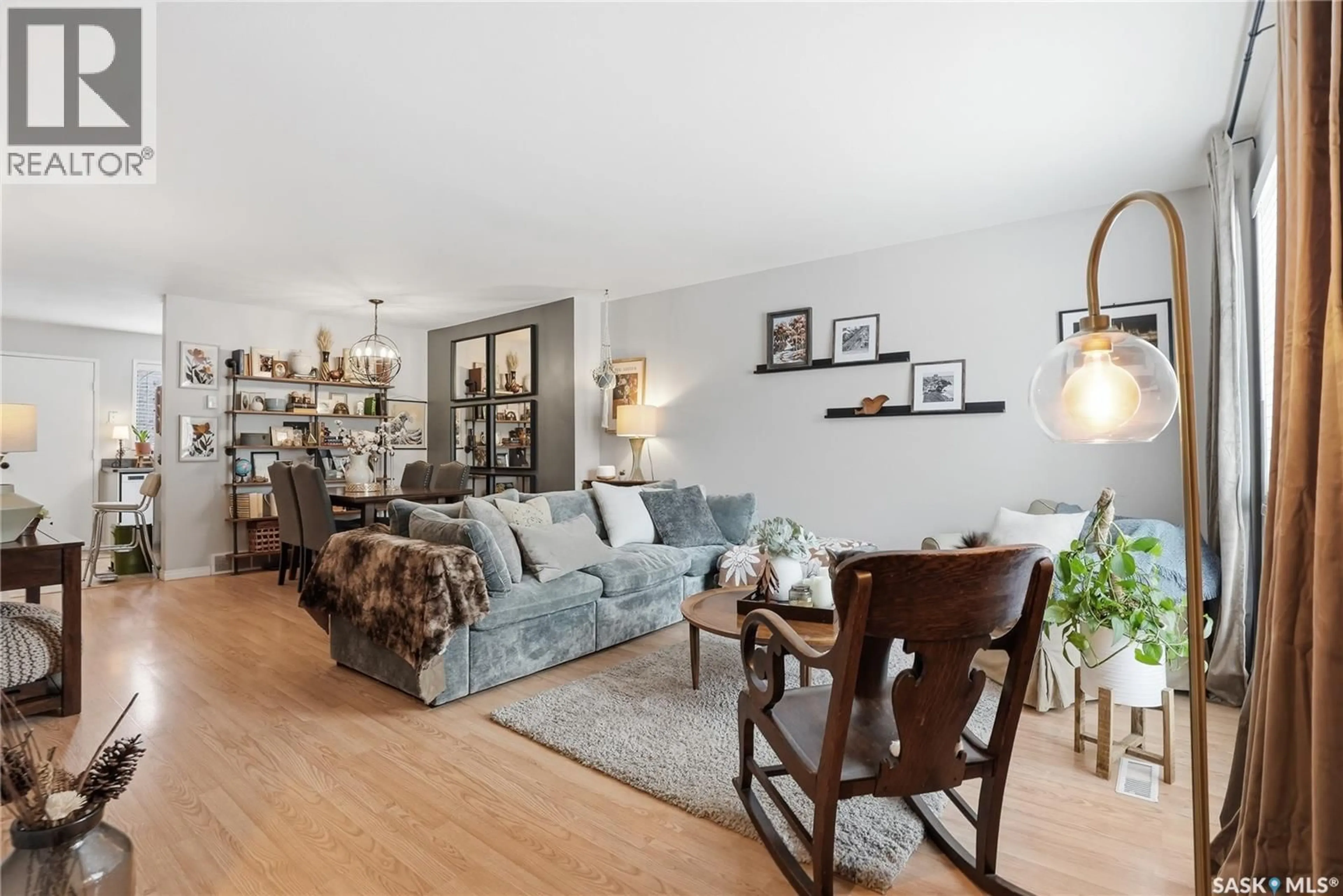 Living room with furniture, wood/laminate floor for 16 425 PINEHOUSE DRIVE, Saskatoon Saskatchewan S7K5K2