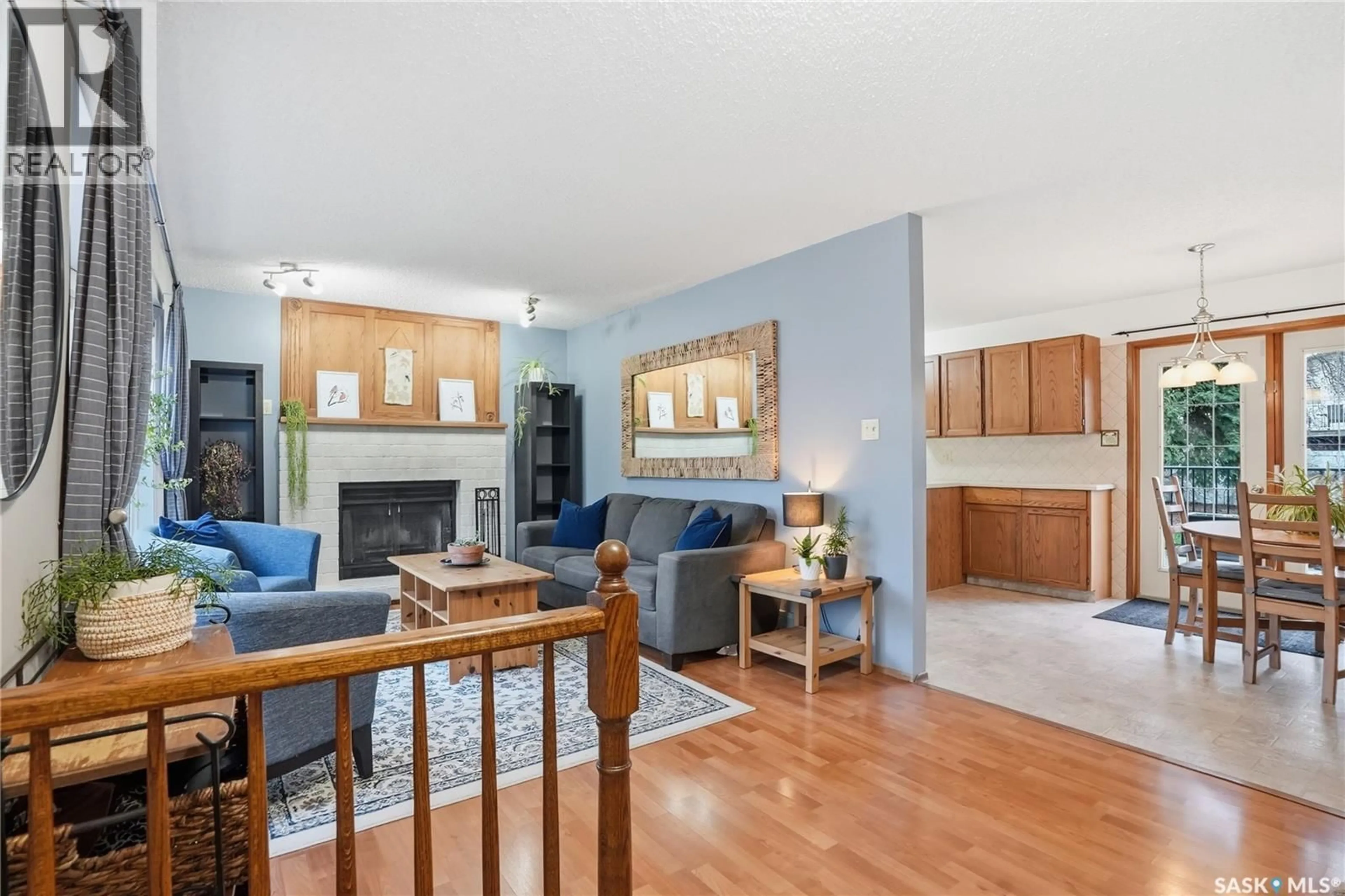 Living room with furniture, wood/laminate floor for 174 RAO CRESCENT, Saskatoon Saskatchewan S7K6V9