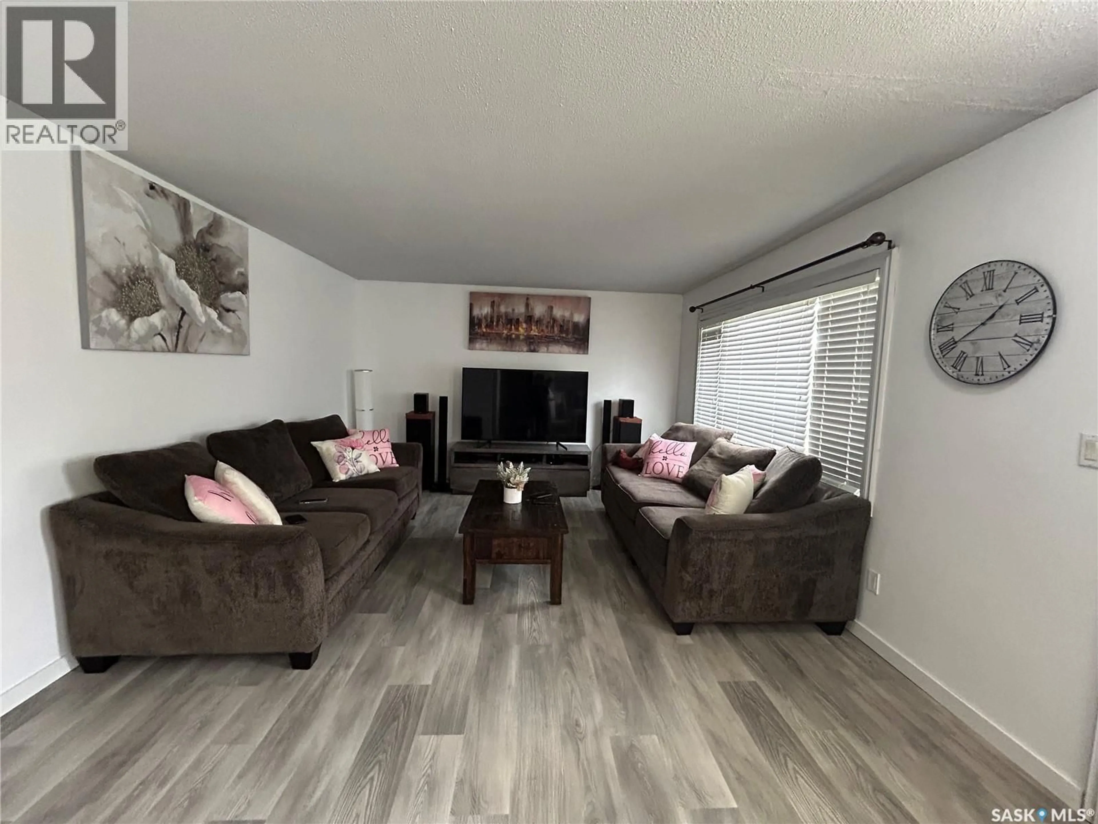 Living room with furniture, wood/laminate floor for 2007 MAYFAIR BAY, Estevan Saskatchewan S4A1X7