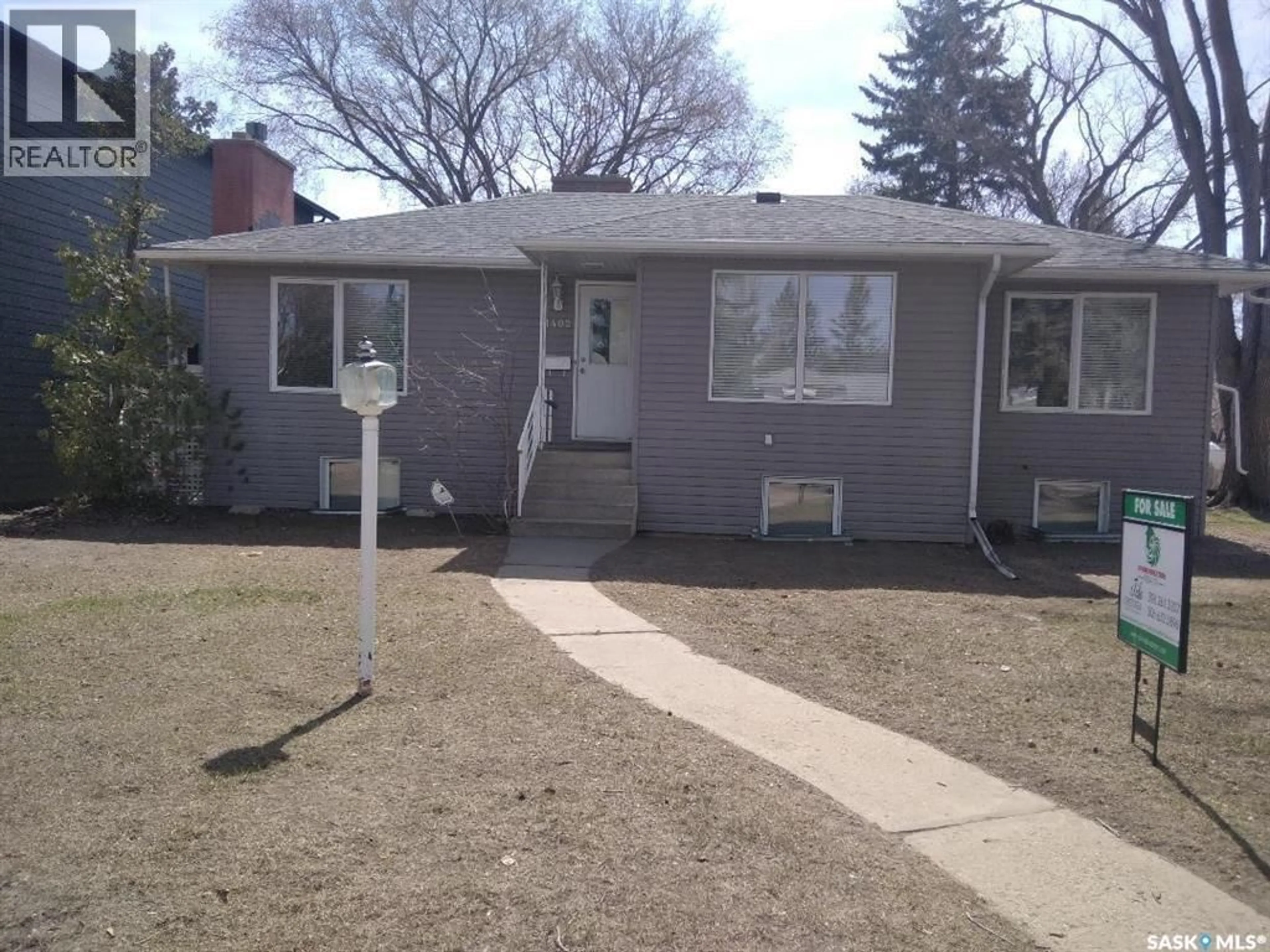 Home with vinyl exterior material, street for 1402 14TH STREET, Saskatoon Saskatchewan S7H0A8