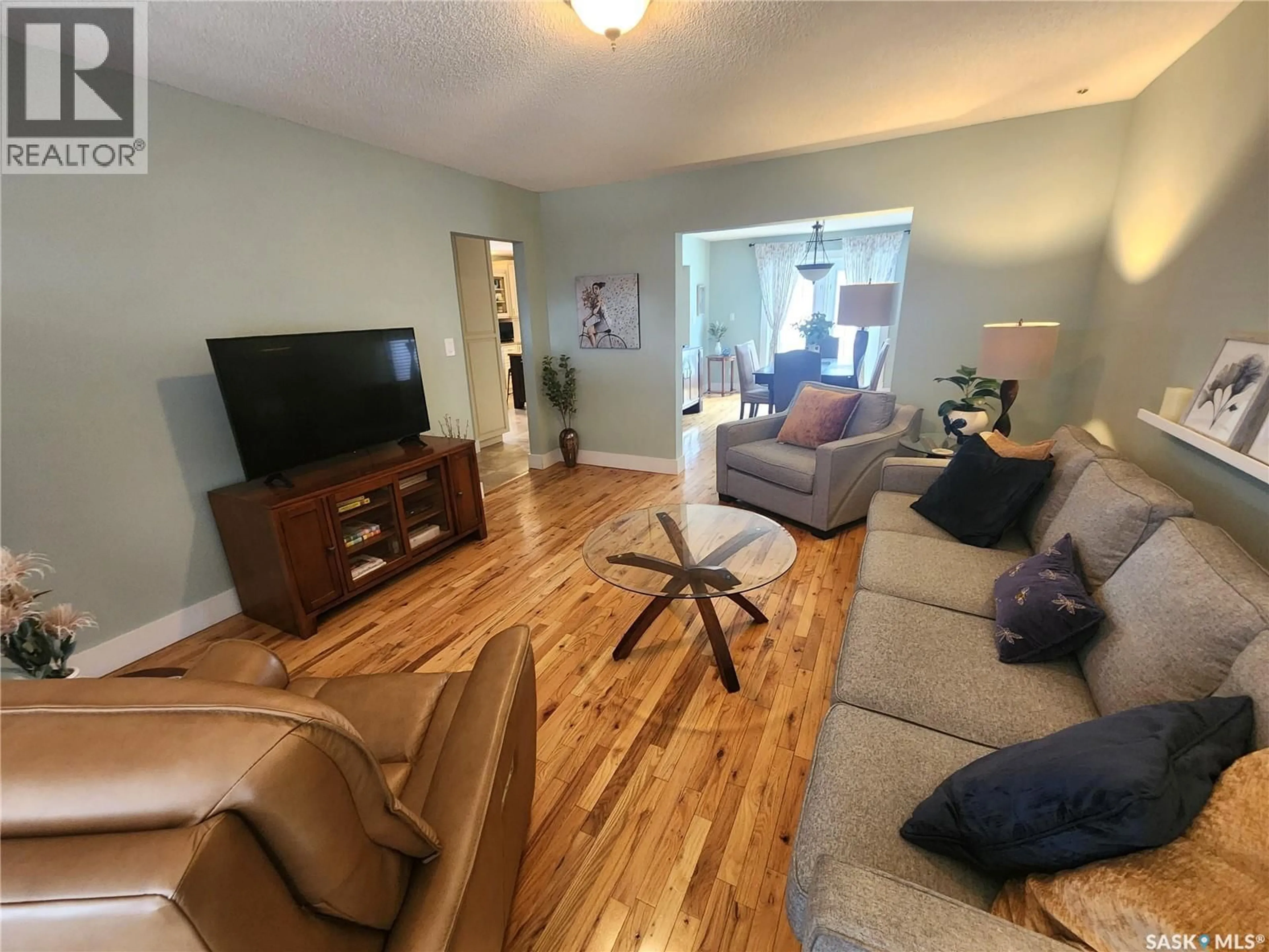 Living room with furniture, wood/laminate floor for 947 ALBERT STREET, Estevan Saskatchewan S4A1S2