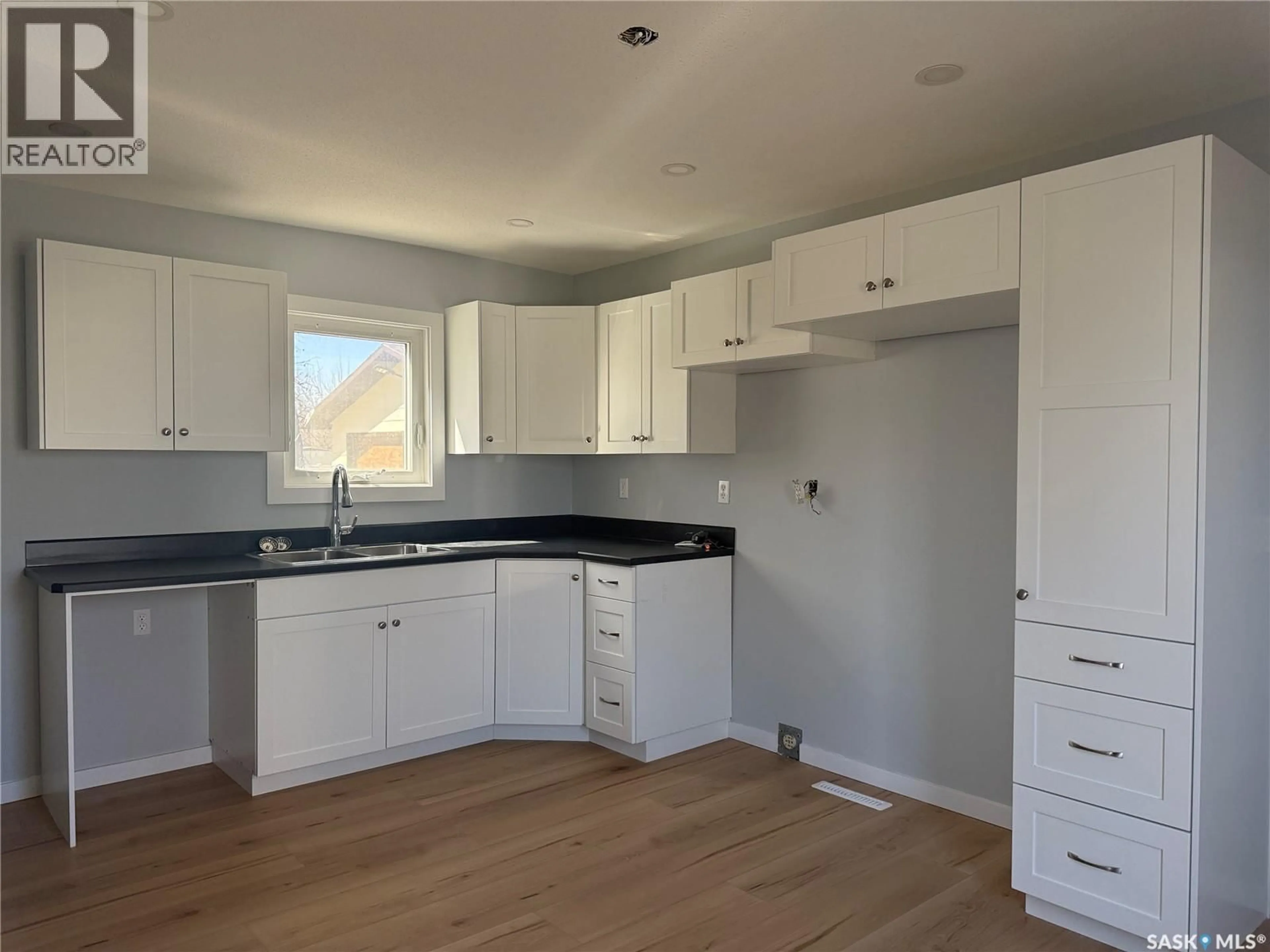 Open concept kitchen, wood/laminate floor for 414 3RD AVENUE, Dodsland Saskatchewan S0L0V0
