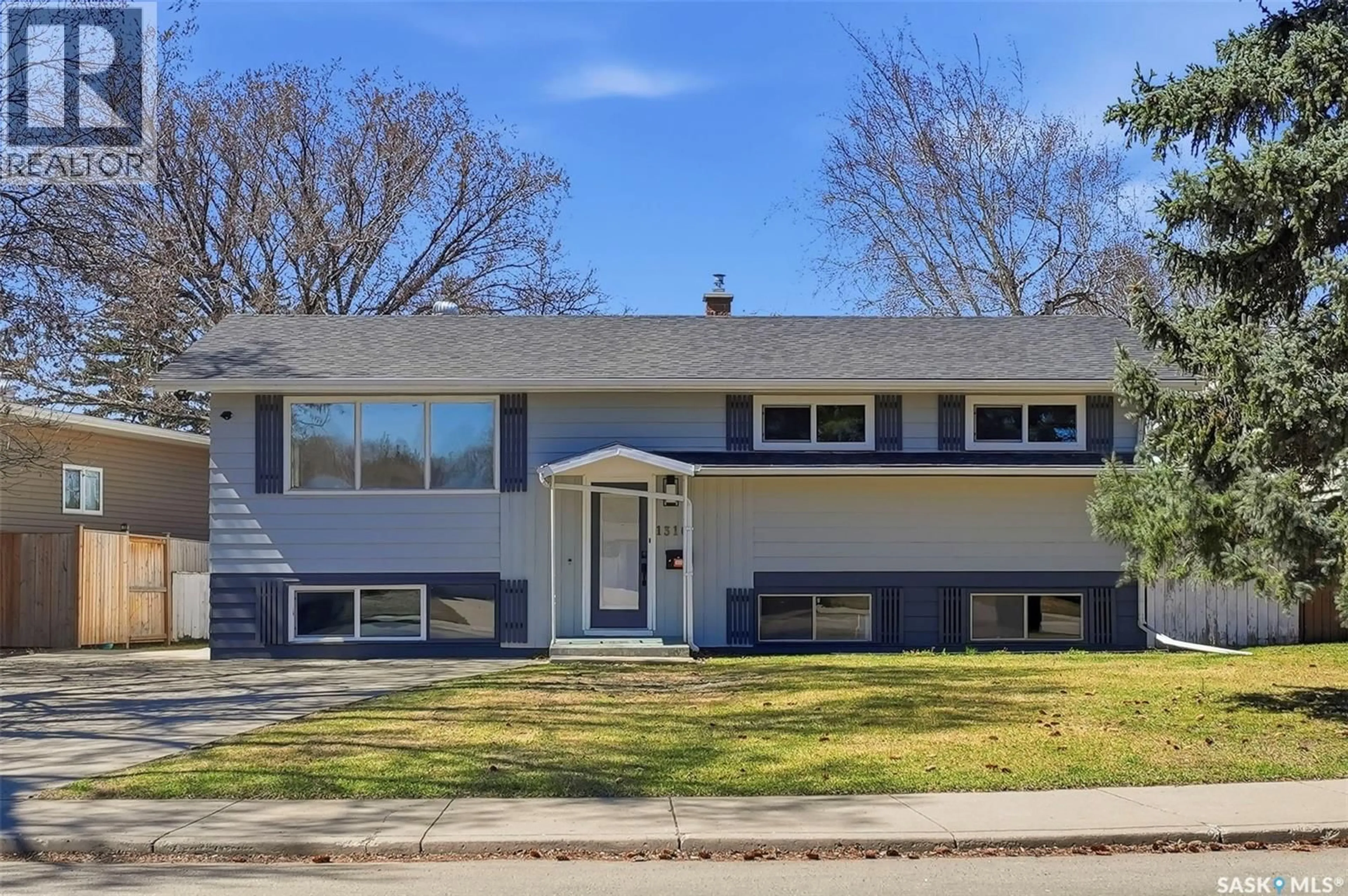 Home with vinyl exterior material, street for 1310 CENTRE EAST, Saskatoon Saskatchewan S7J3A9