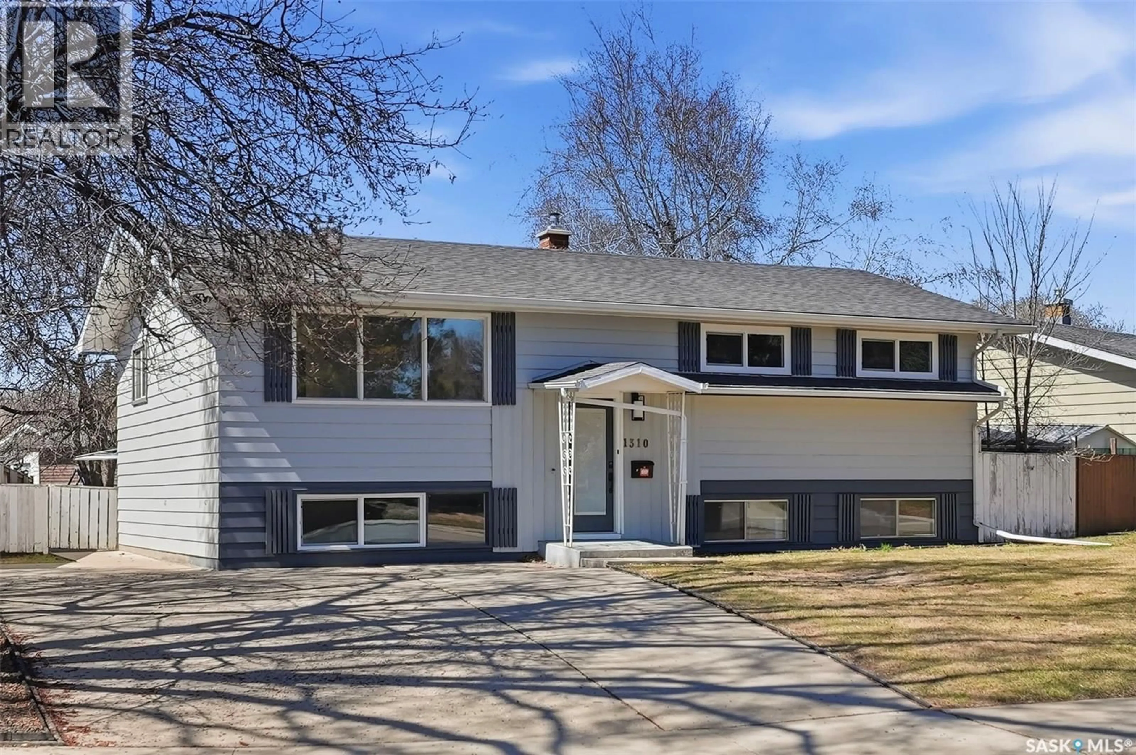 Home with vinyl exterior material, street for 1310 CENTRE EAST, Saskatoon Saskatchewan S7J3A9