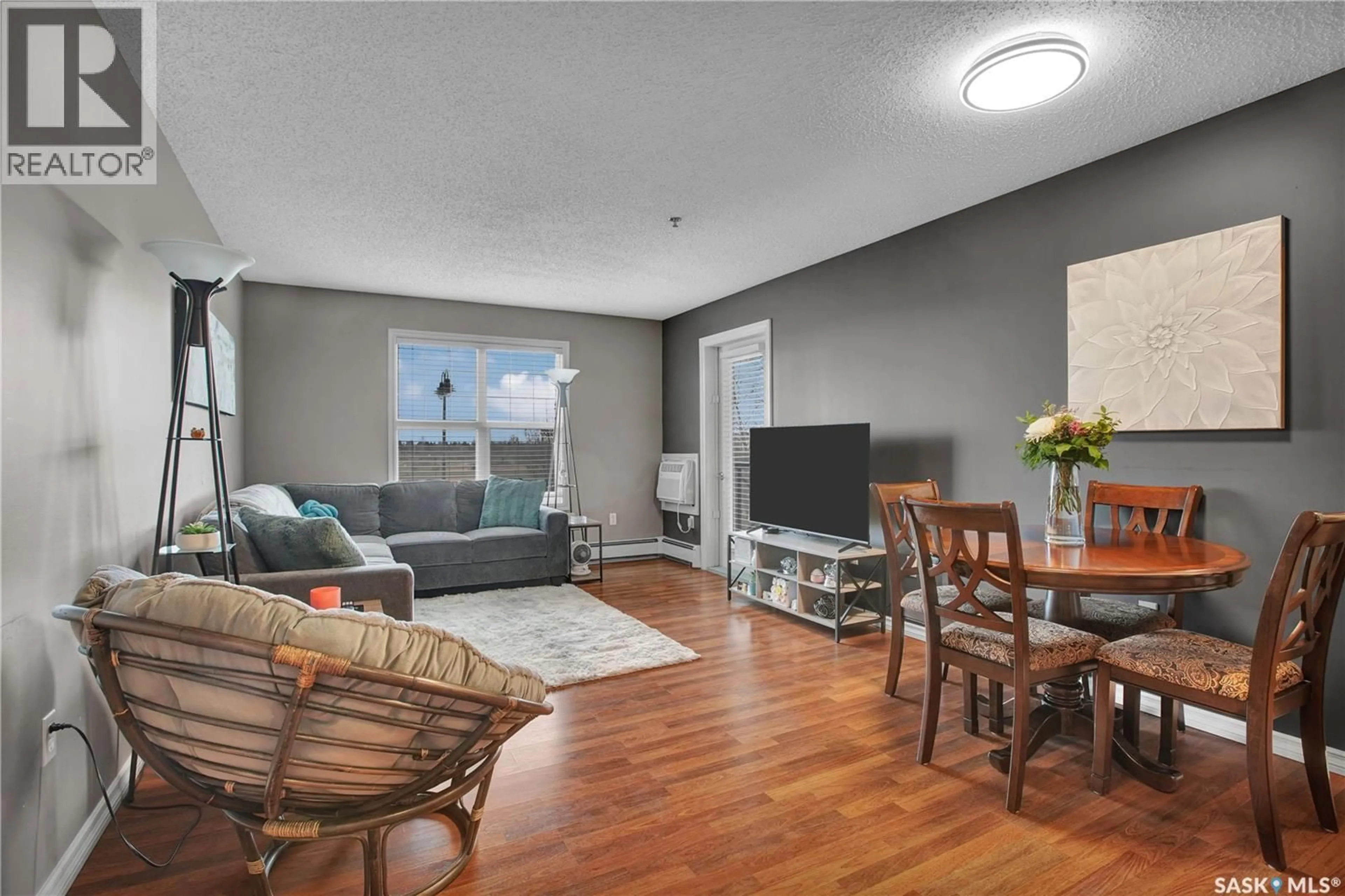 Living room with furniture, wood/laminate floor for B207 - 103 WELLMAN CRESCENT, Saskatoon Saskatchewan S7T0C1