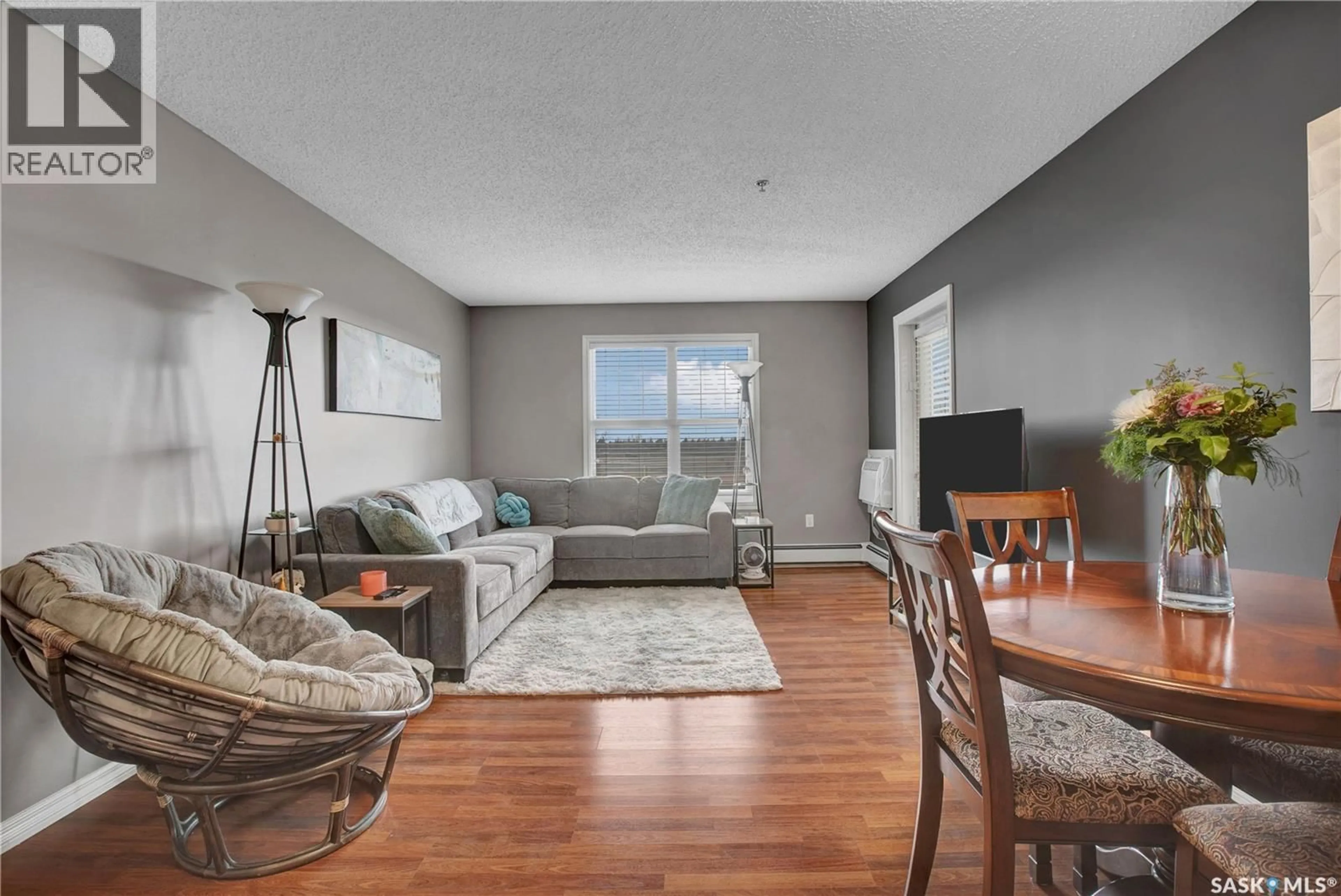 Living room with furniture, wood/laminate floor for B207 - 103 WELLMAN CRESCENT, Saskatoon Saskatchewan S7T0C1
