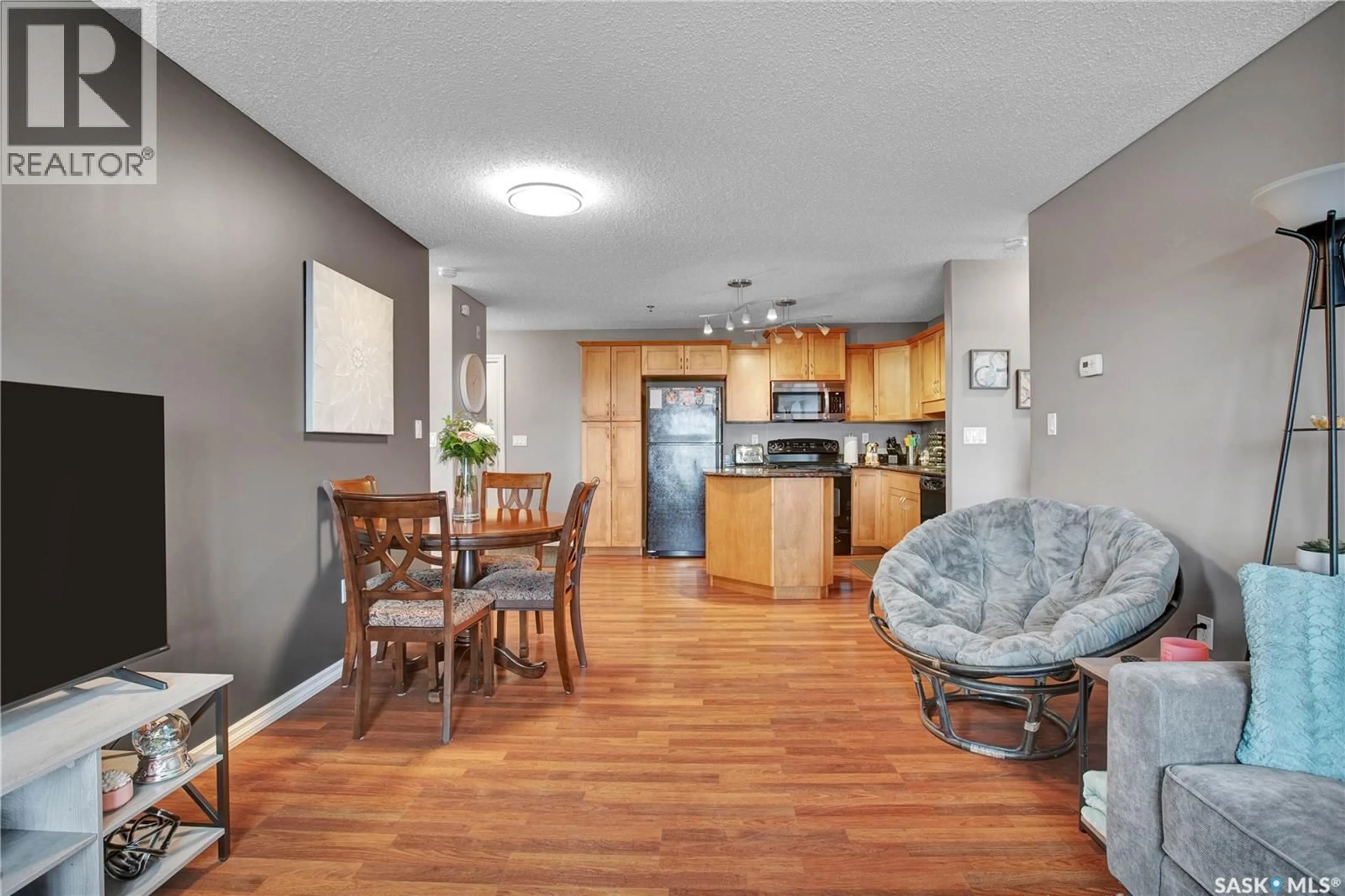 Open concept kitchen, wood/laminate floor for B207 - 103 WELLMAN CRESCENT, Saskatoon Saskatchewan S7T0C1