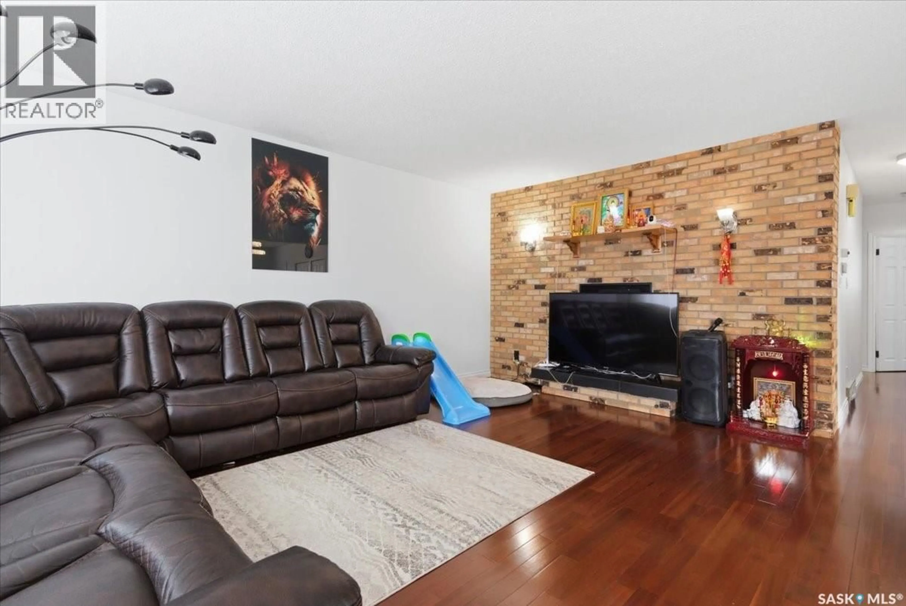 Living room with furniture, wood/laminate floor for 205 BROAD STREET, Regina Saskatchewan S4R2X7