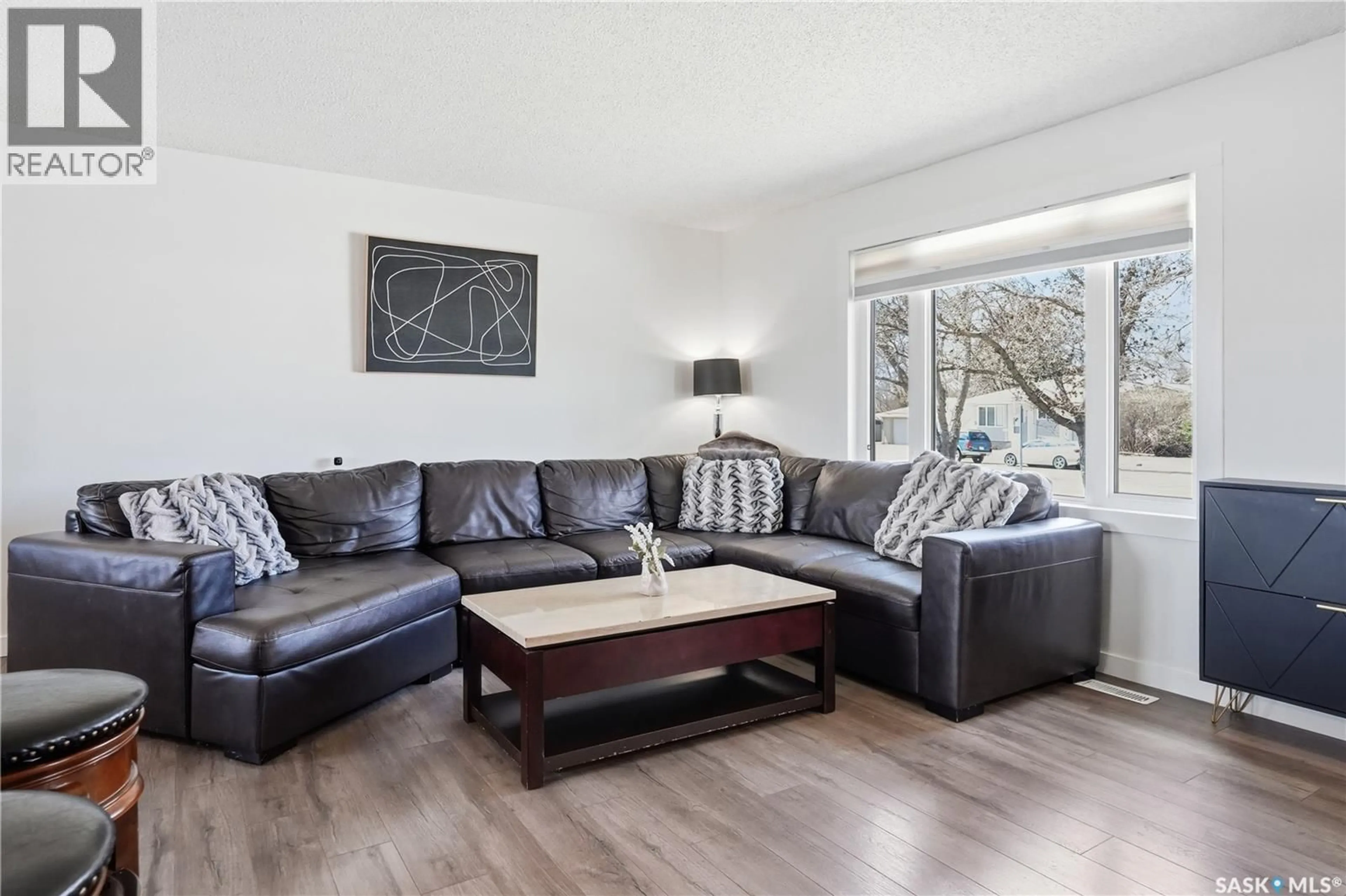 Living room with furniture, wood/laminate floor for 78 VERNON CRESCENT, Regina Saskatchewan S4R7P5