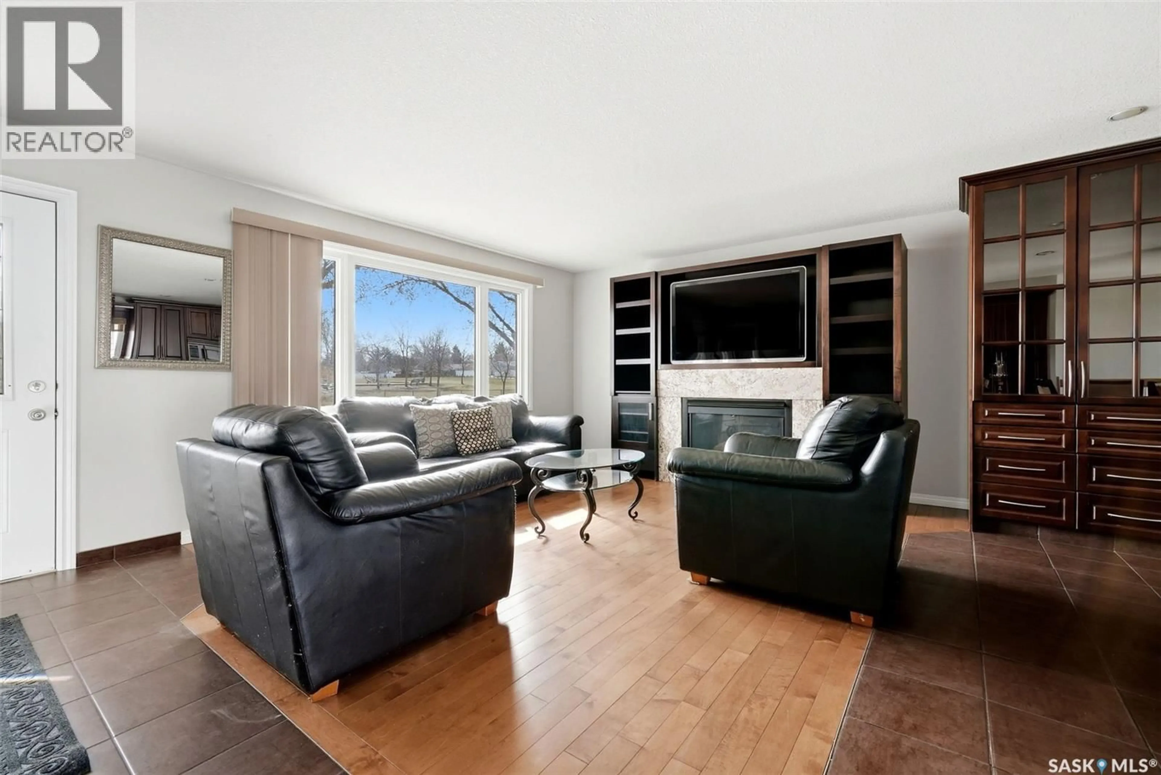 Living room with furniture, wood/laminate floor for 730 MCINTOSH STREET, Regina Saskatchewan S4R5Z4