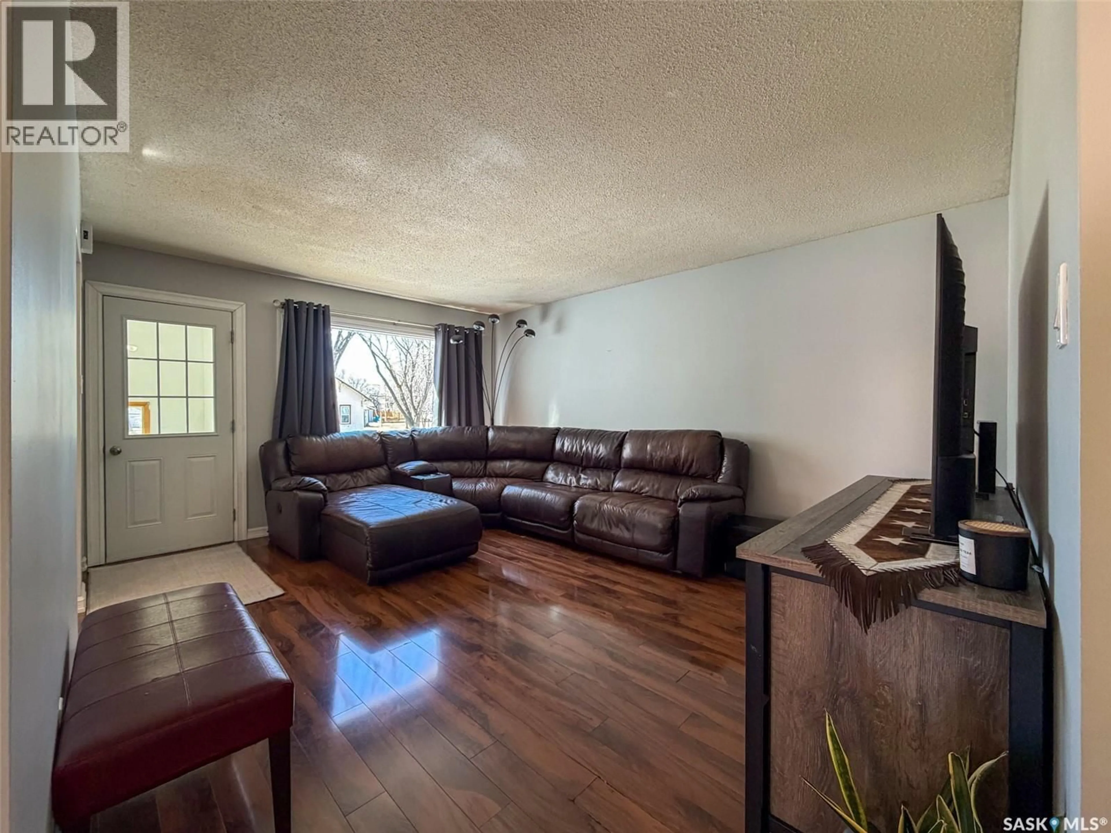 Living room with furniture, wood/laminate floor for 420 1ST STREET, Shaunavon Saskatchewan S0N2M0