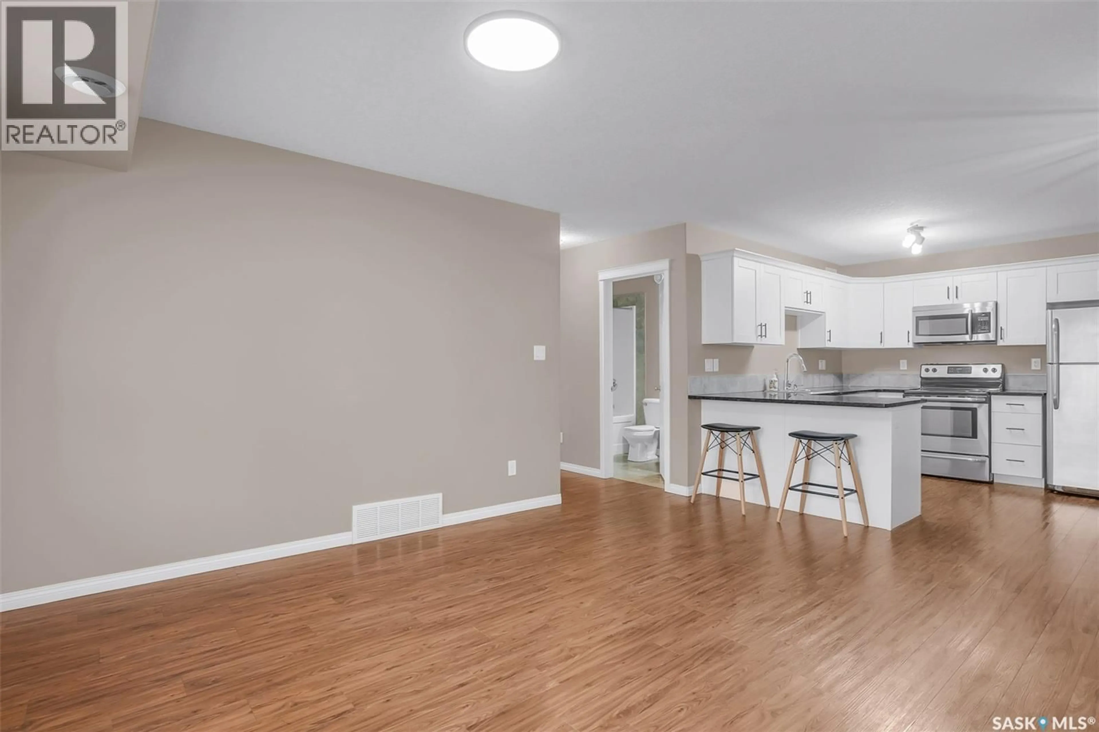Open concept kitchen, wood/laminate floor for 128 125 WILLIS CRESCENT, Saskatoon Saskatchewan S7T0T1