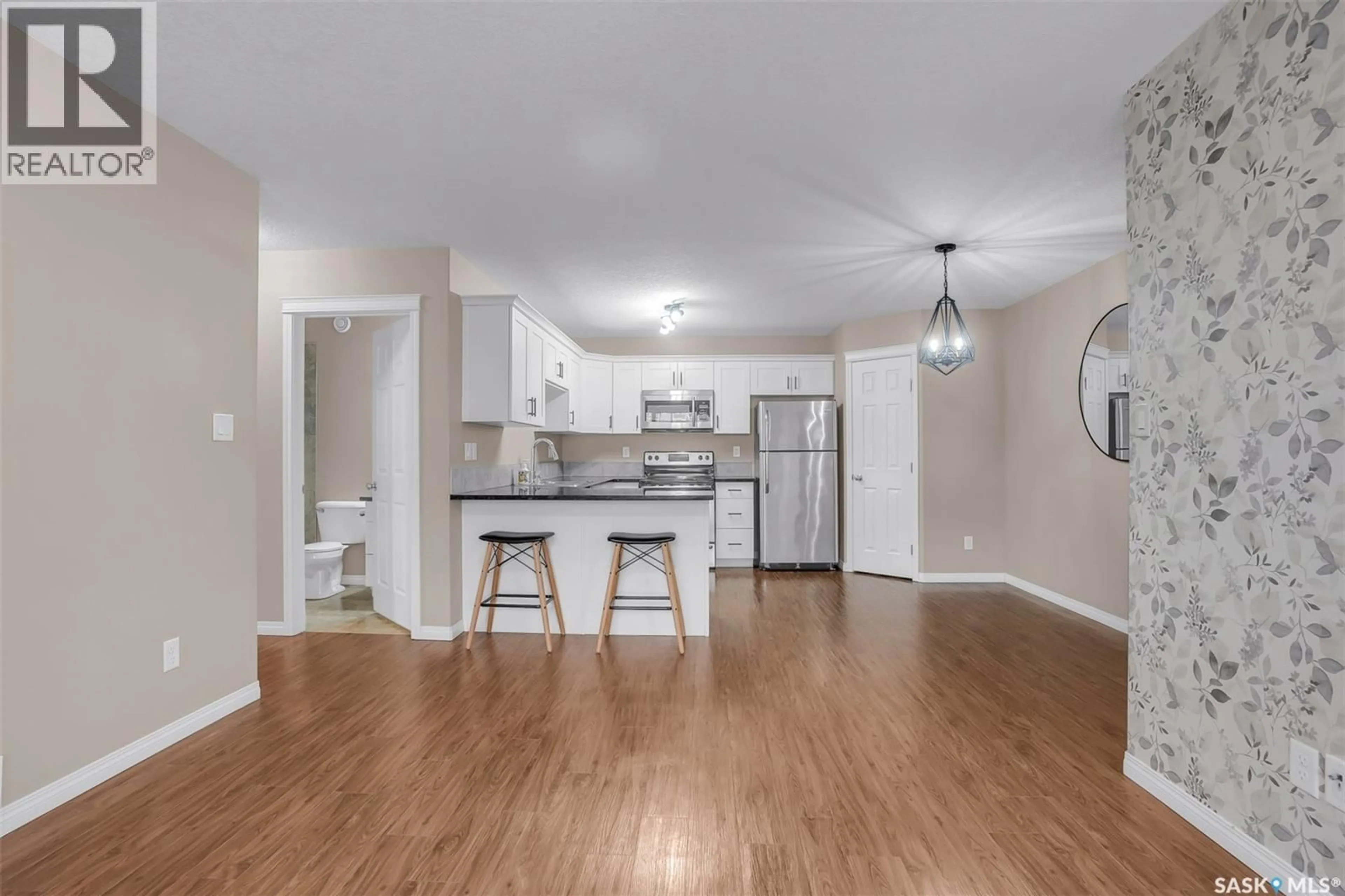 Open concept kitchen, wood/laminate floor for 128 125 WILLIS CRESCENT, Saskatoon Saskatchewan S7T0T1