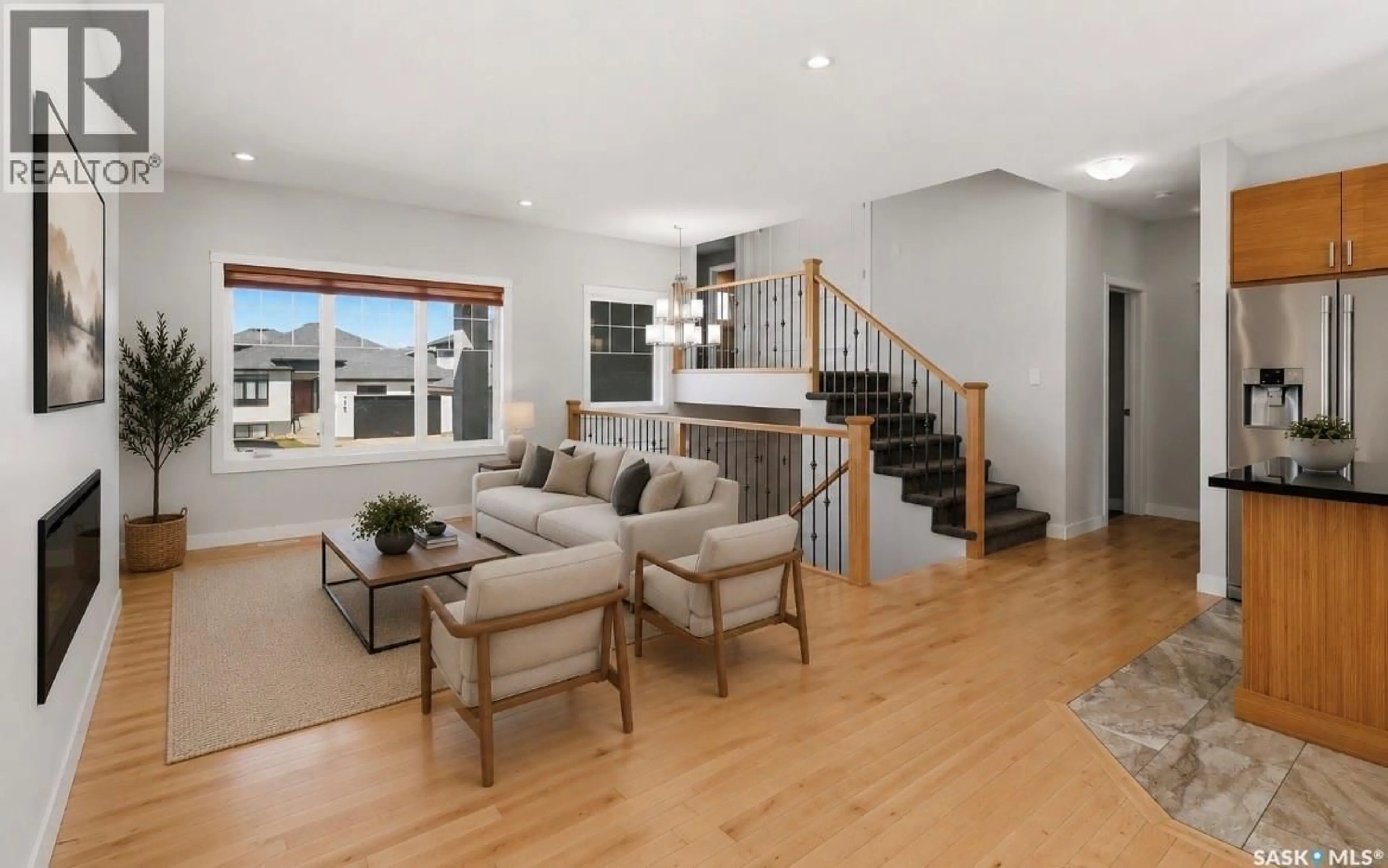 Living room with furniture, wood/laminate floor for 175 GILLIES LANE, Saskatoon Saskatchewan S7V0J8