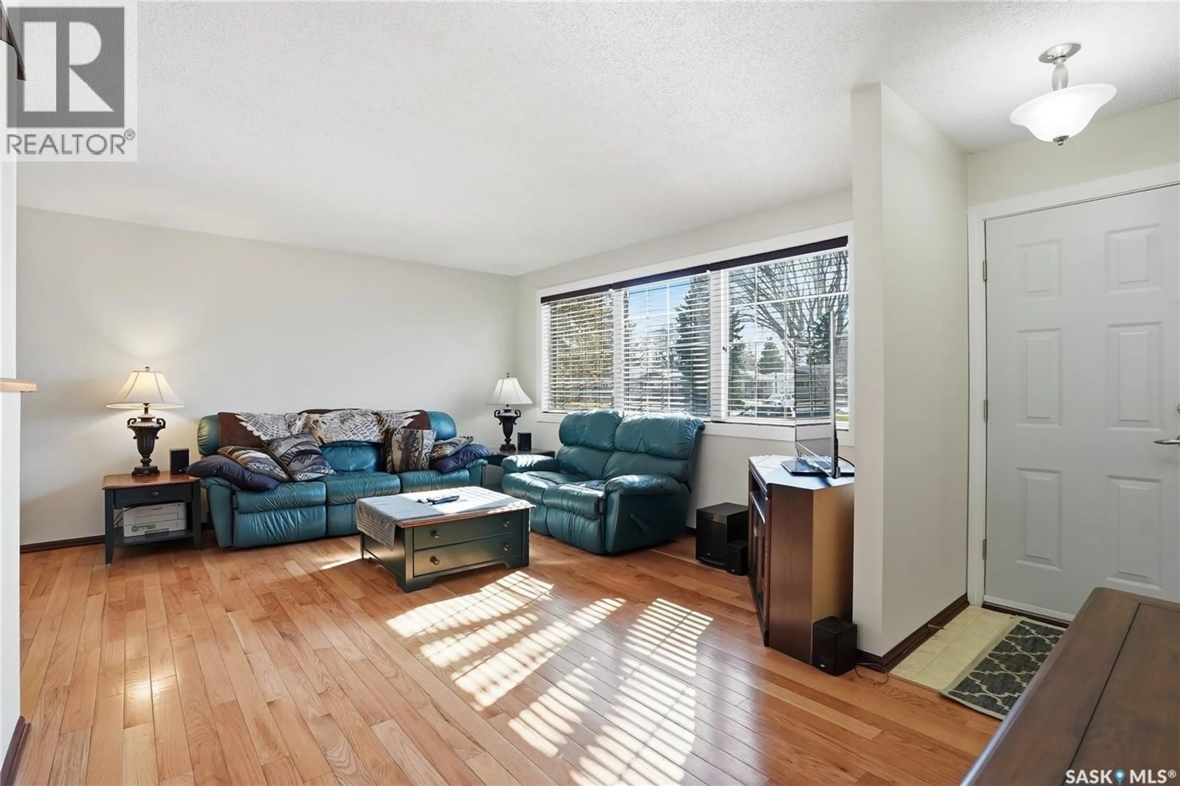 Living room with furniture, wood/laminate floor for 2 HARDY CRESCENT, Saskatoon Saskatchewan S7H3E7