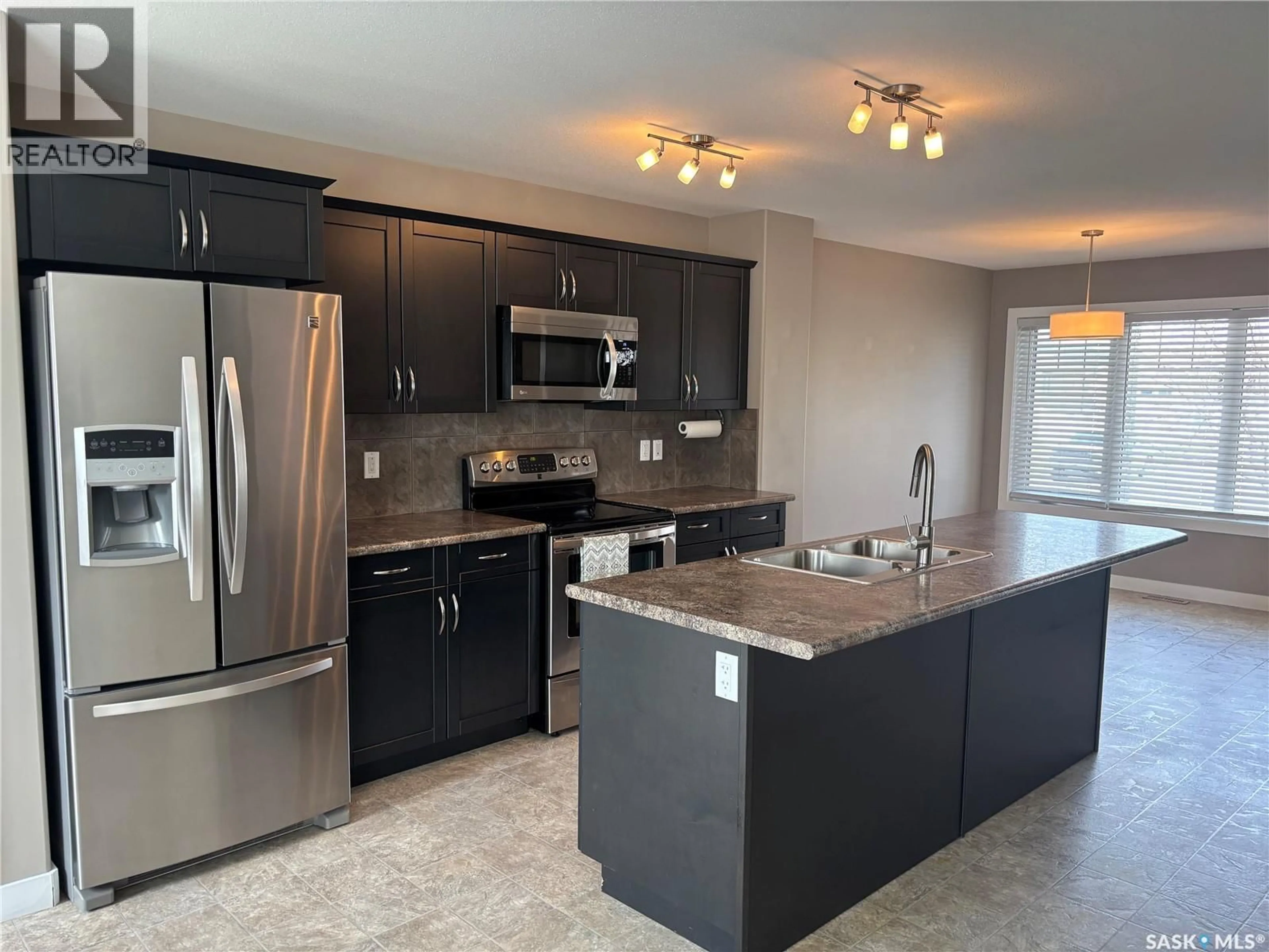 Open concept kitchen, ceramic/tile floor for E - 4501 GREEN POPLAR LANE, Regina Saskatchewan S4V3A5