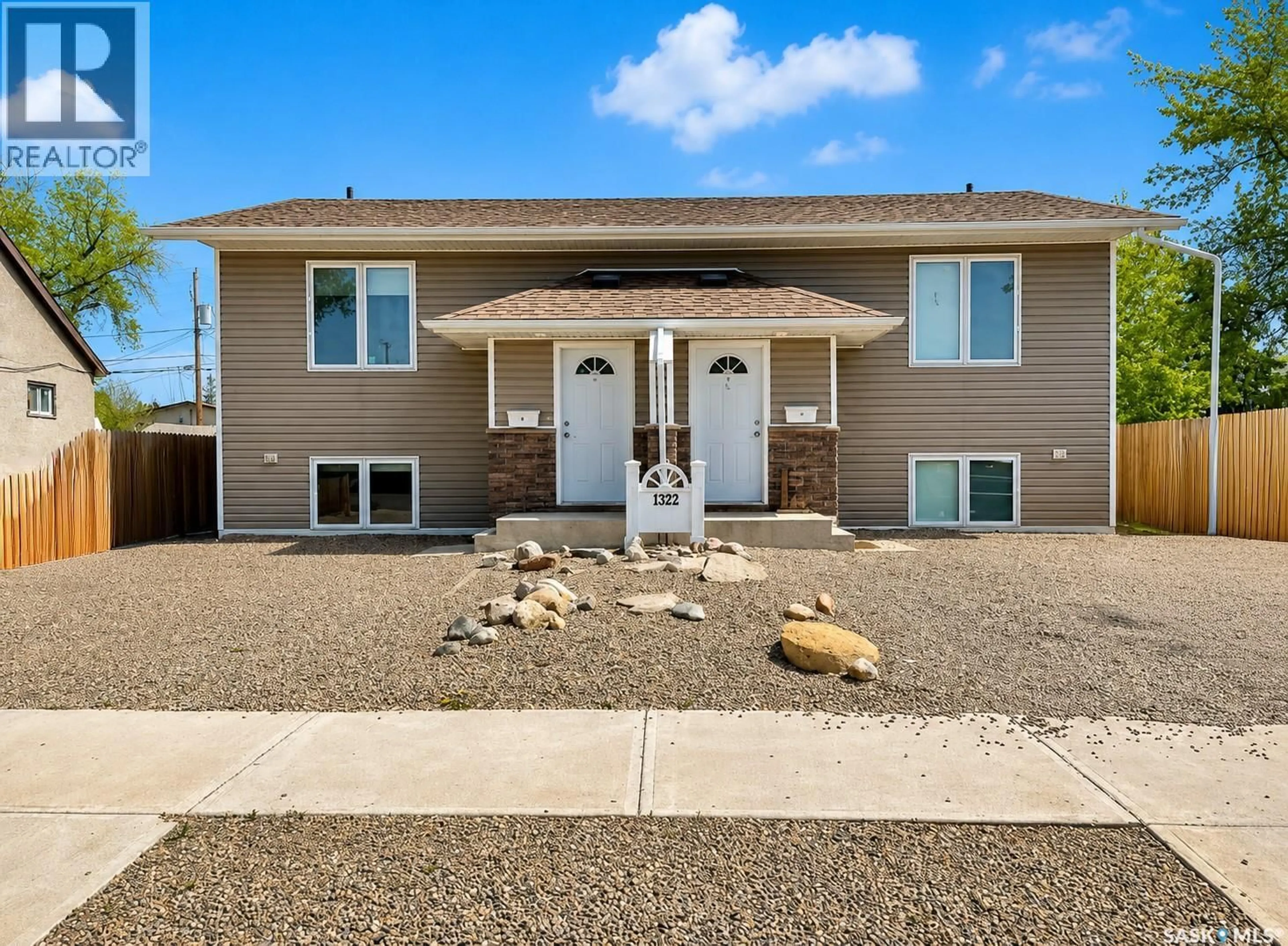 Home with vinyl exterior material, street for A & B - 1322 107TH STREET, North Battleford Saskatchewan S9A1Z7