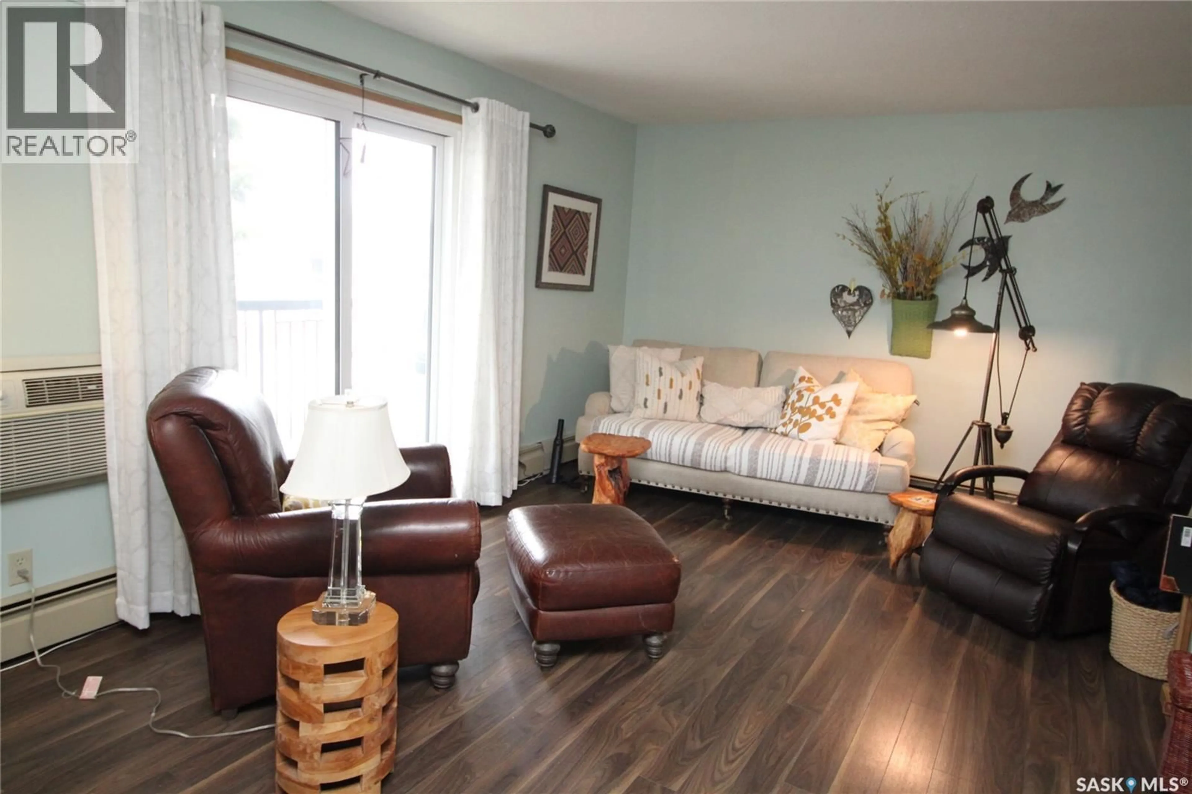 Living room with furniture, wood/laminate floor for 104 - 2013 ARLINGTON AVENUE, Saskatoon Saskatchewan S7J2H6