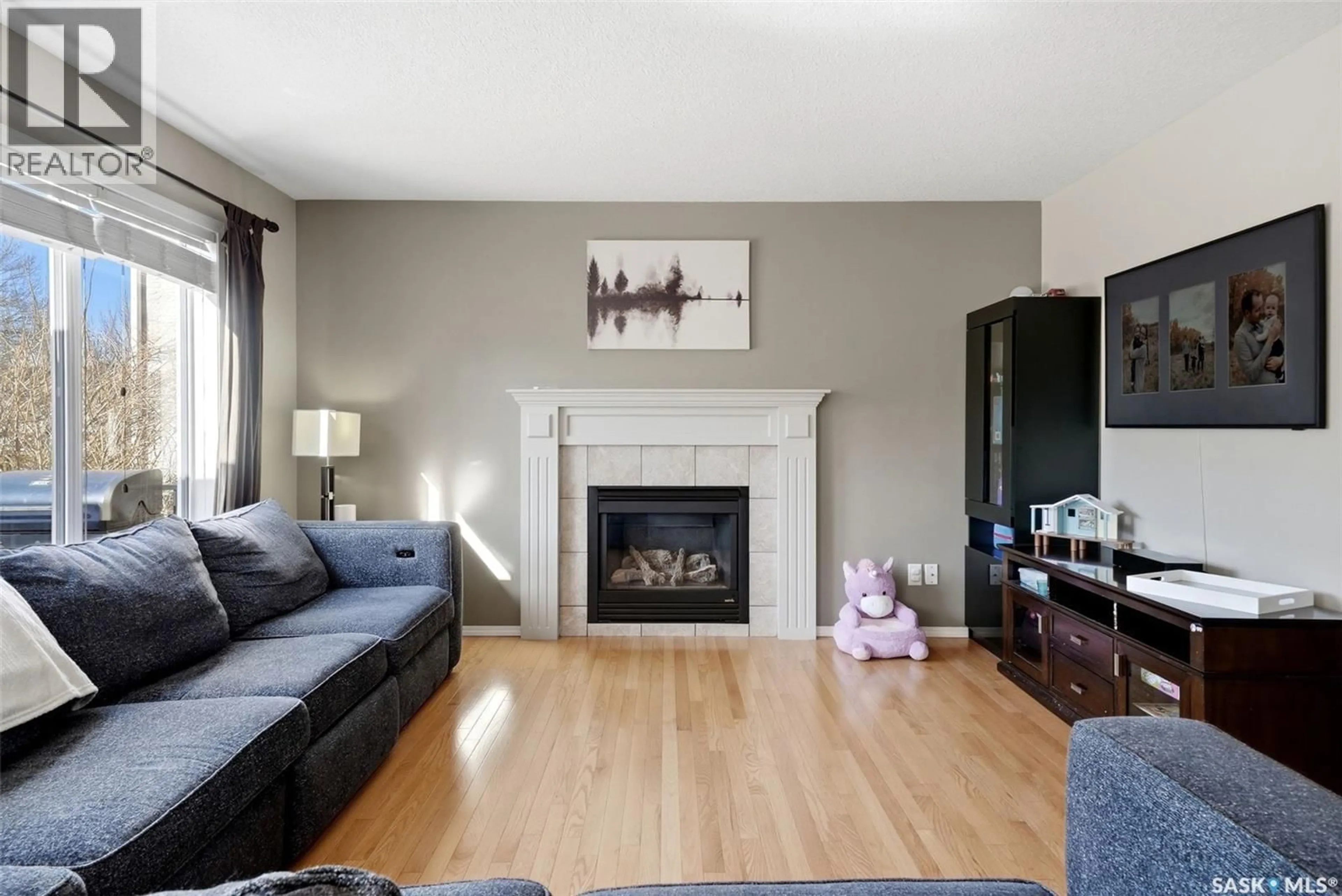 Living room with furniture, wood/laminate floor for 10290 WASCANA ESTATES, Regina Saskatchewan S4V2X3